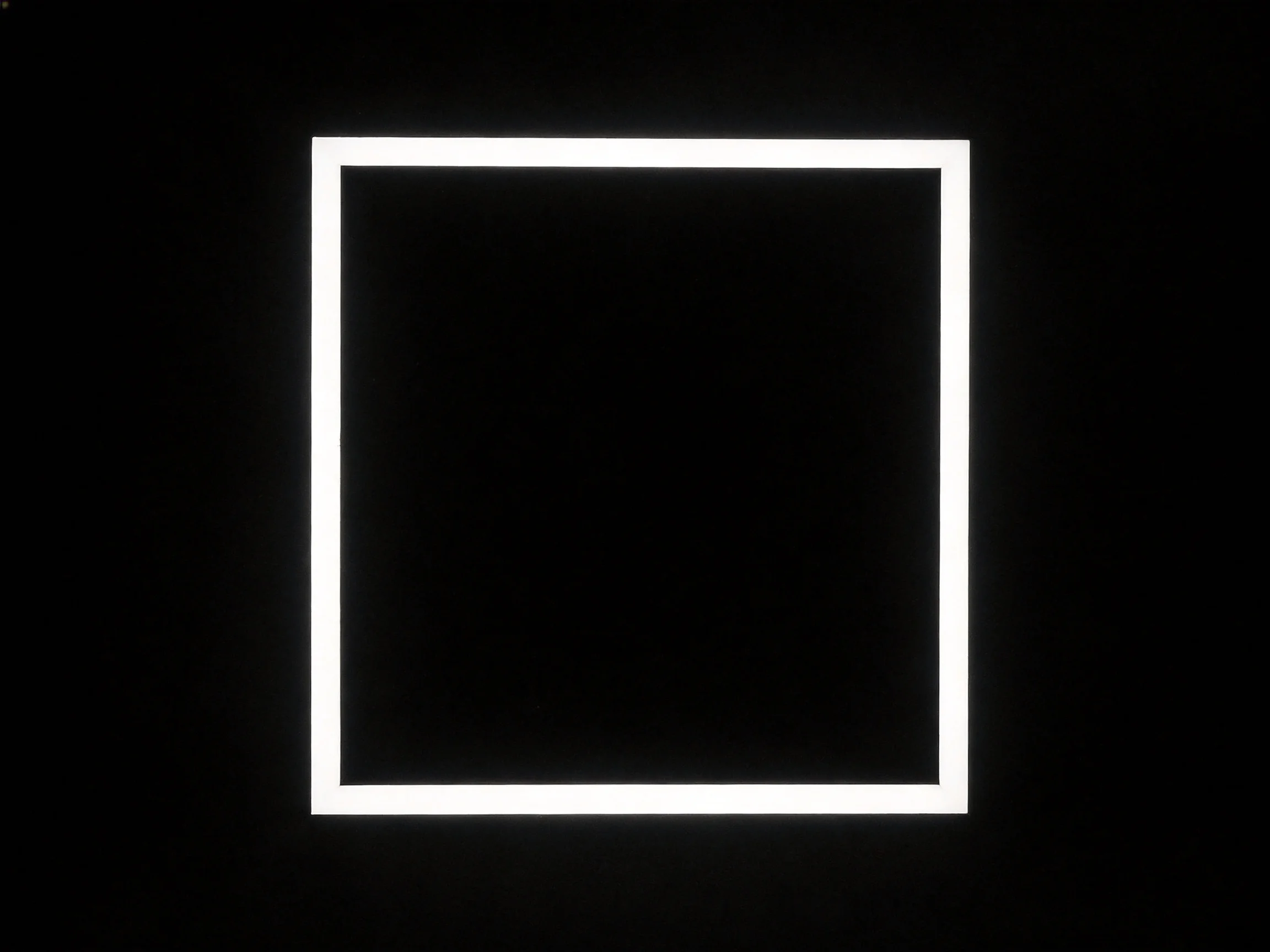 A stark black backdrop with a bright white rectangular frame
