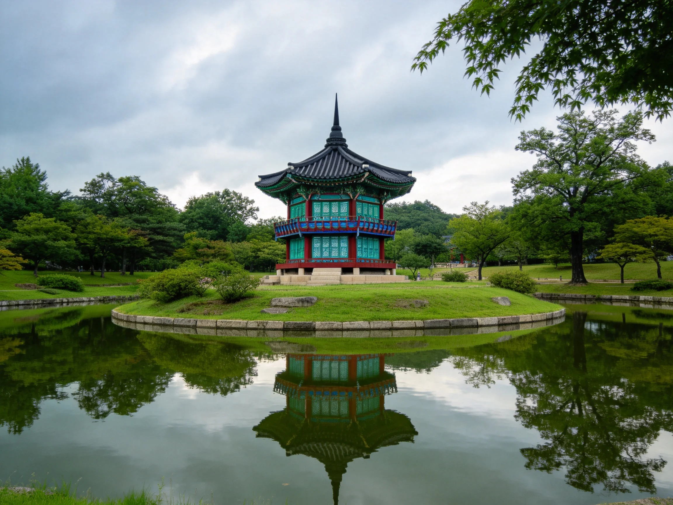 A colorful traditional pagoda on a grassy island over reflective pond