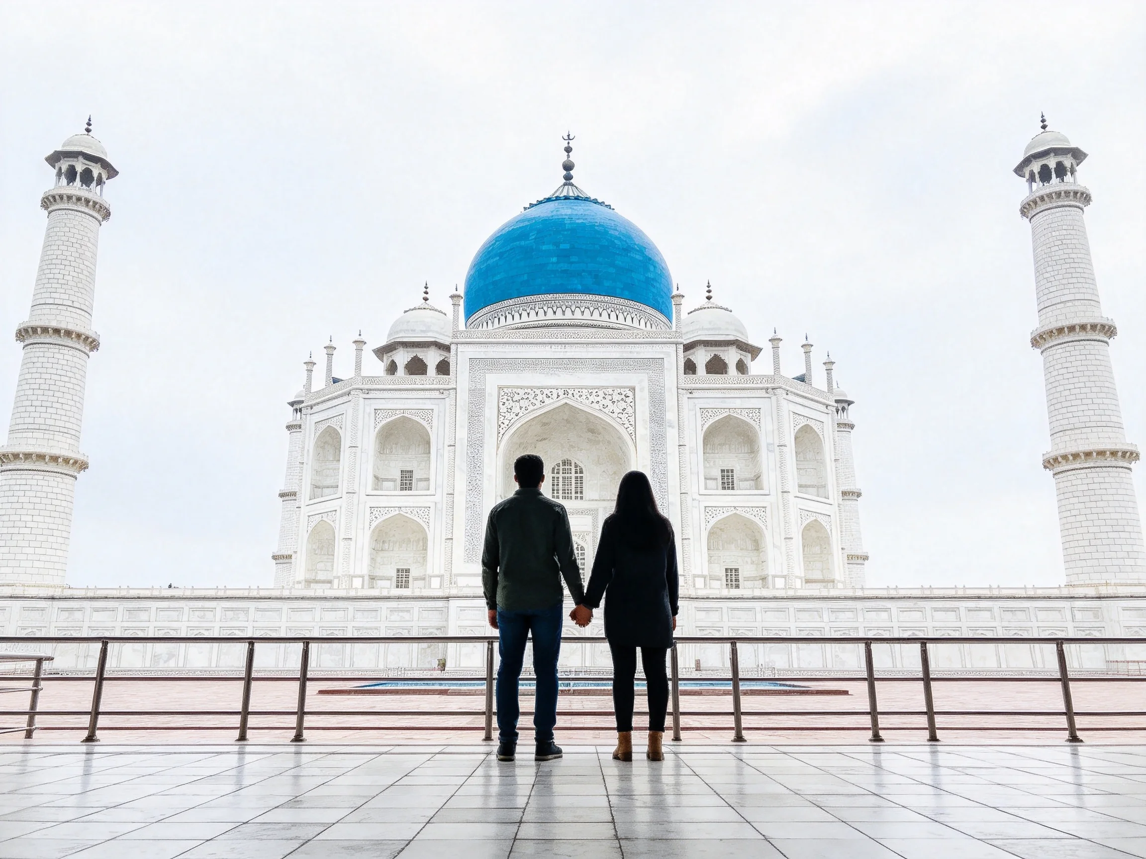 A couple stands before a white marble structure with a blue dome
