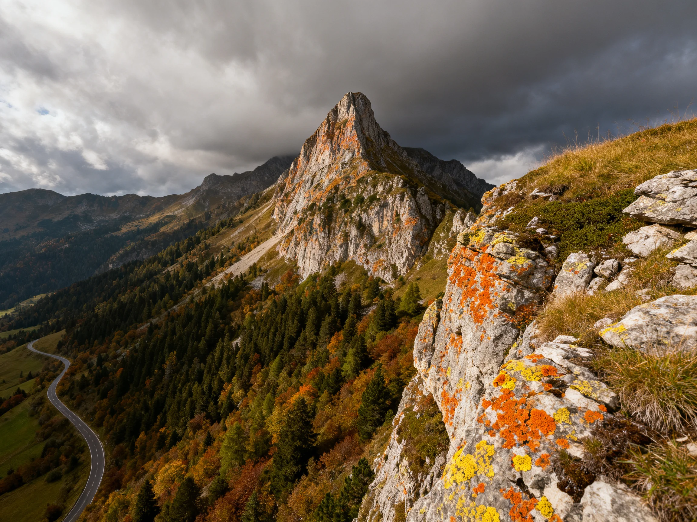 A dramatic mountain peak with orange-yellow lichen-covered rocks