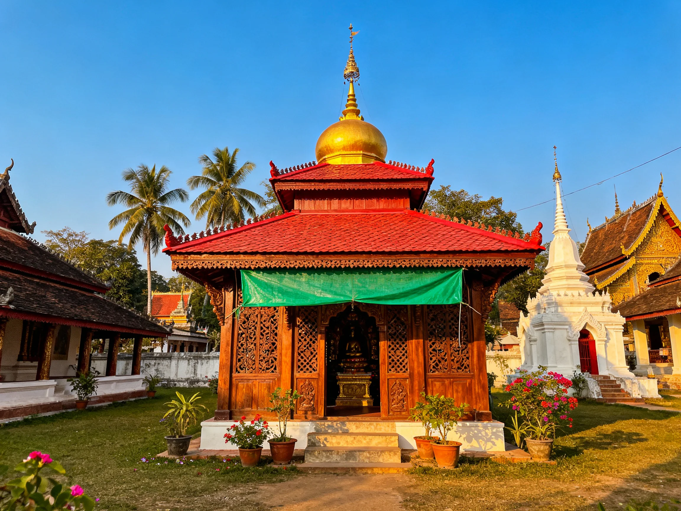 A golden-domed temple with red roof and green tarp among ancient structures