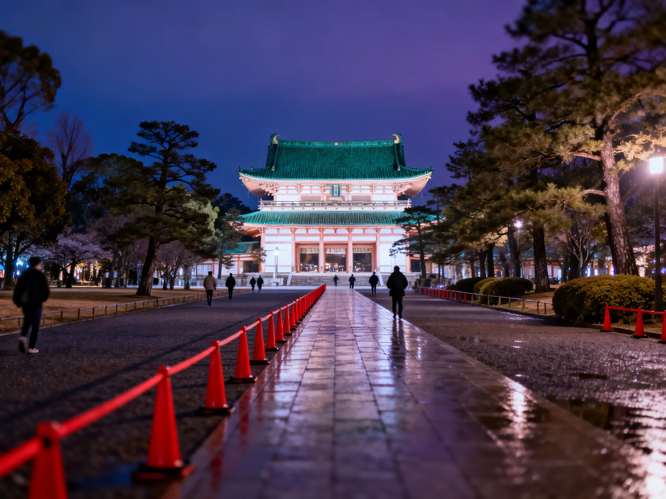 A grand traditional temple with green roof lit at night