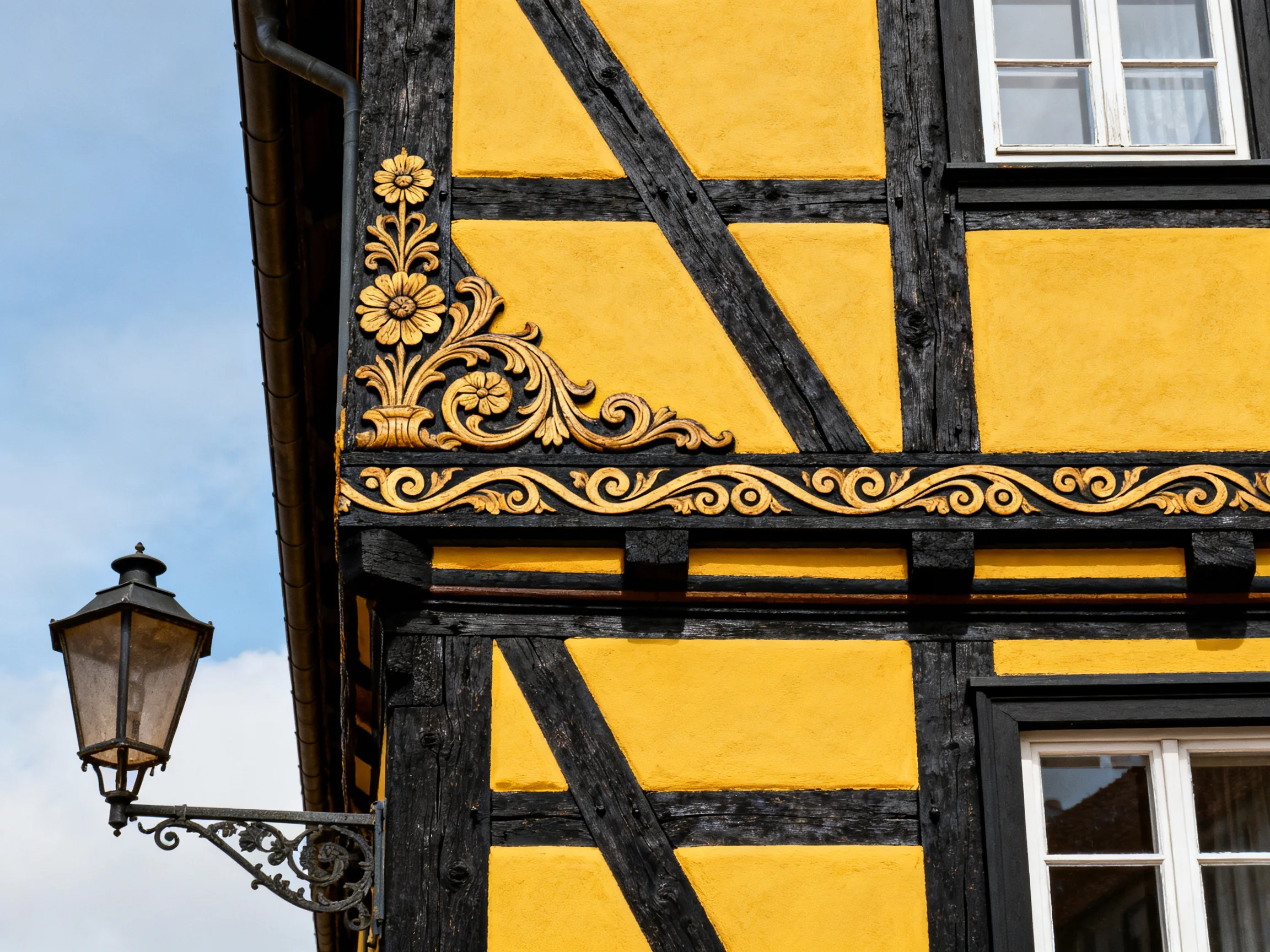 A historic half - timbered house with golden ornamental details