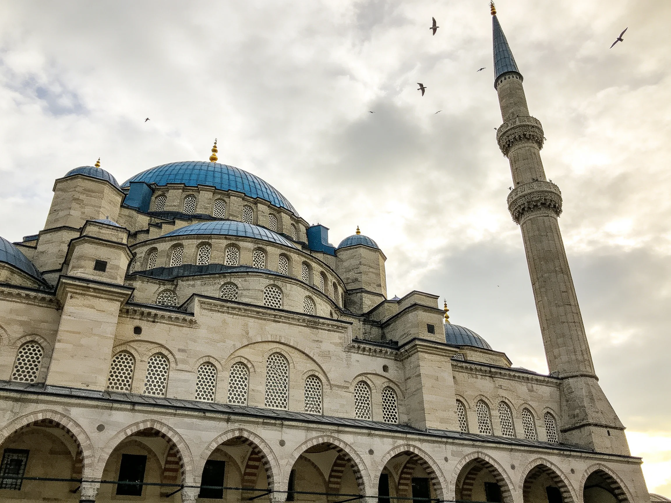 A historic mosque with blue domes and a tall minaret