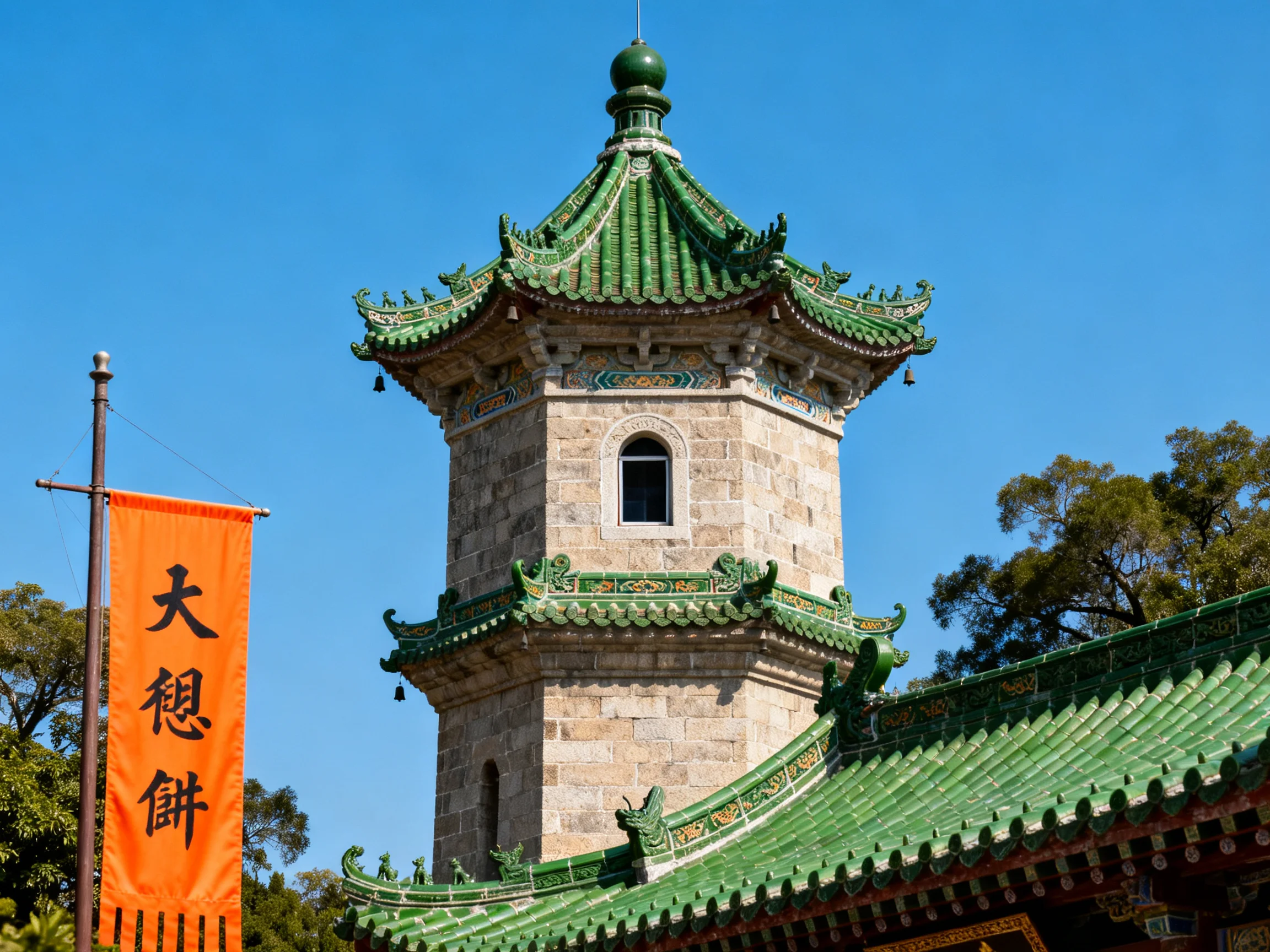 A historic stone tower with green tiled roofs and an orange banner