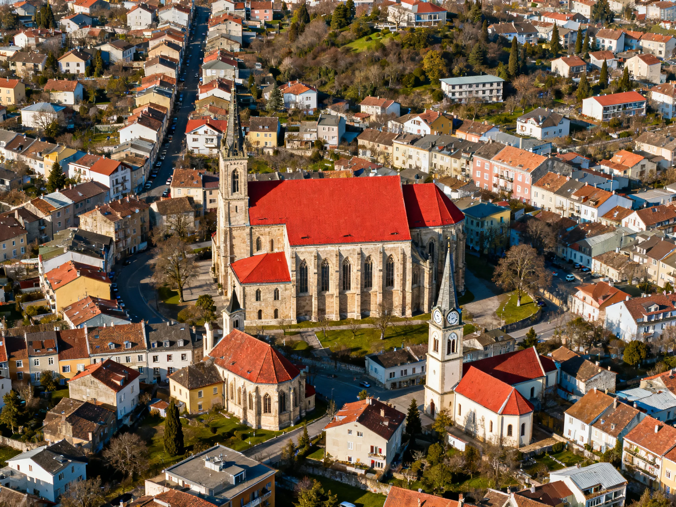 A historic town center with a large church featuring red roofs