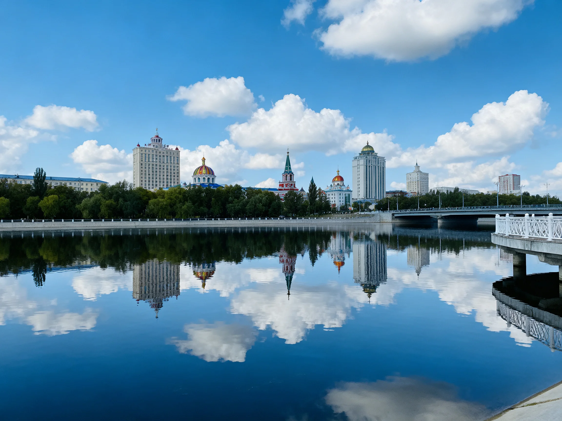 A serene river reflects a cityscape with domed towers and modern skyscrapers
