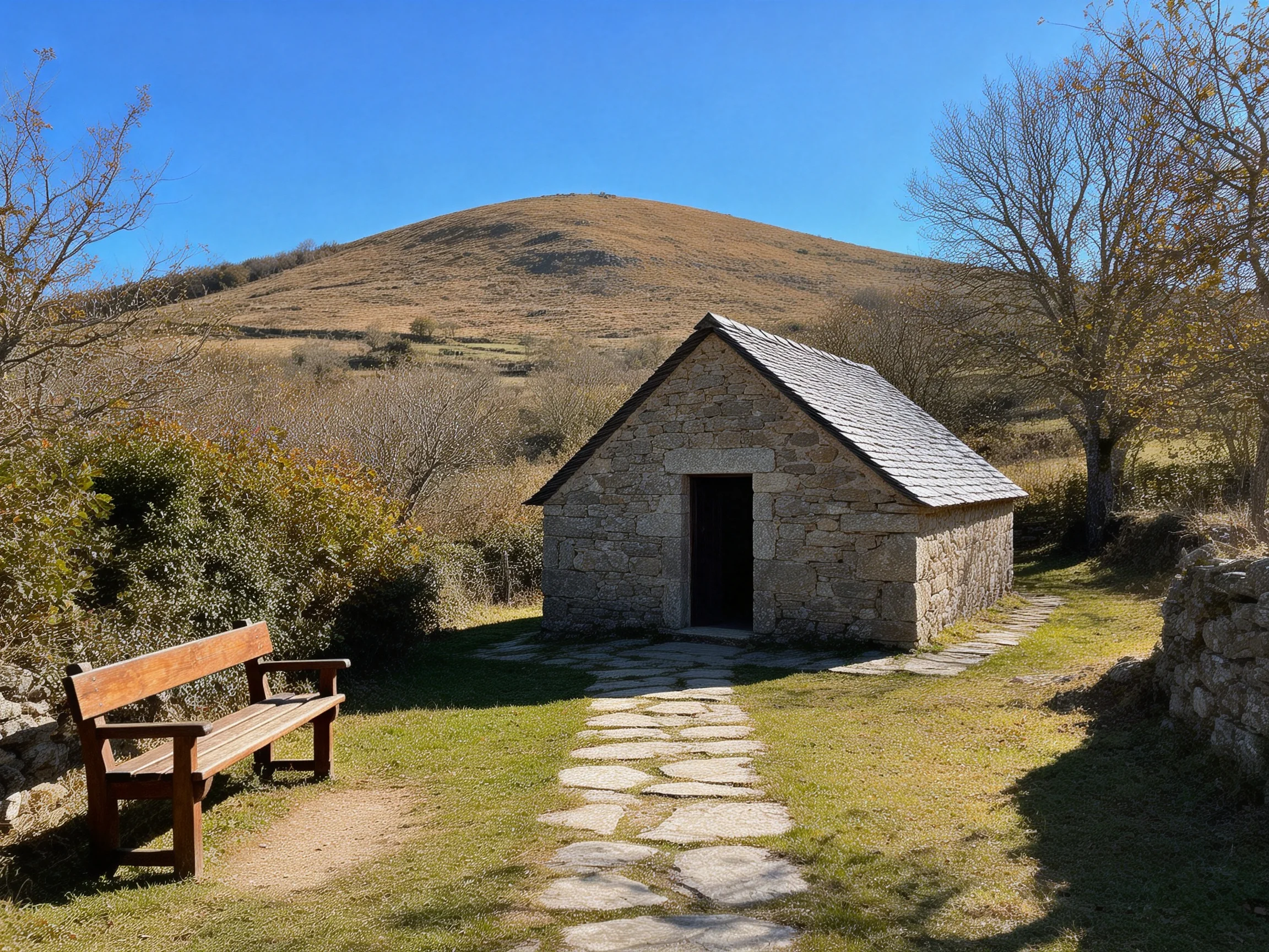 A small stone cottage near a wooden bench with rolling hills