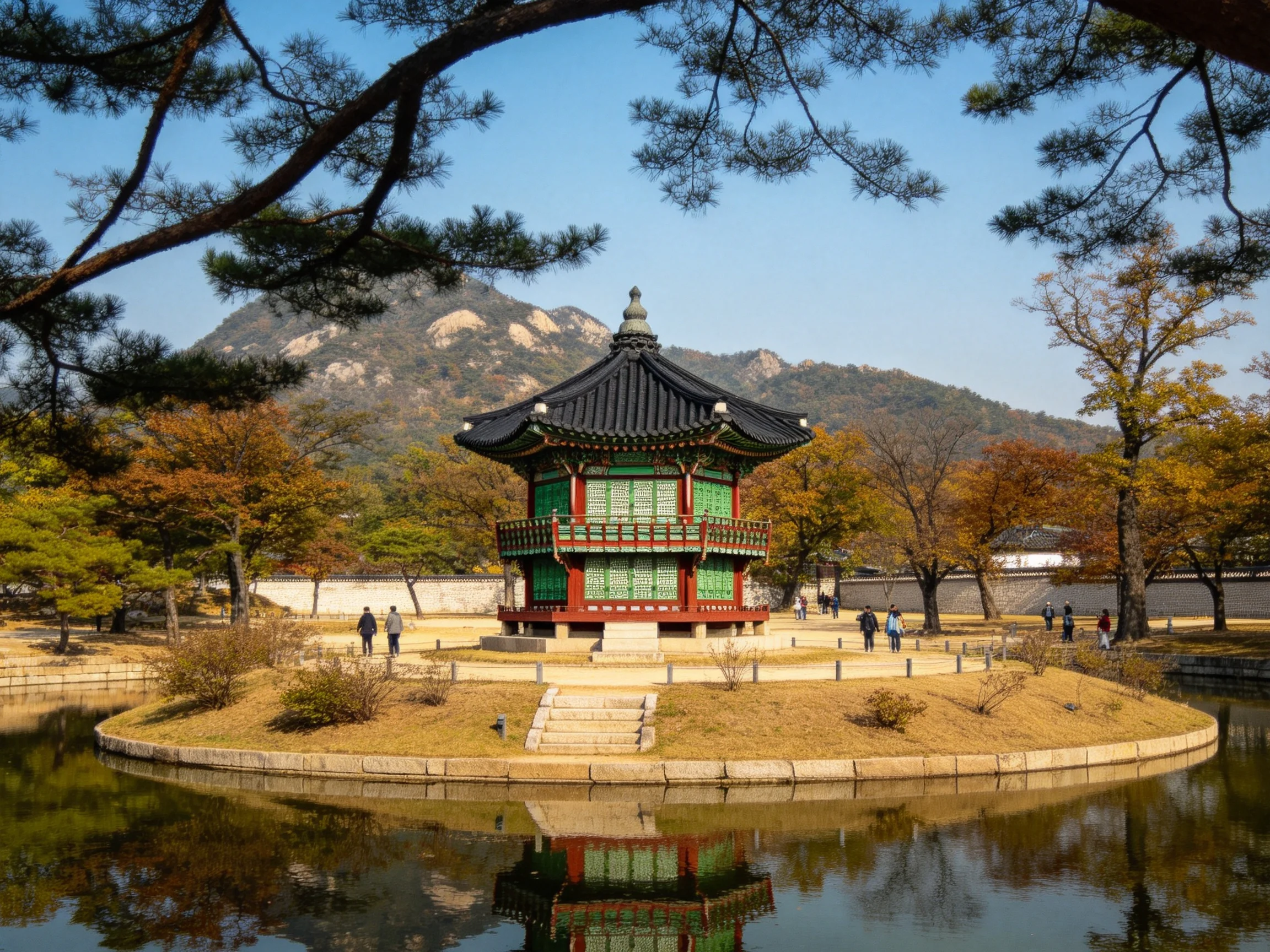 A traditional green-red pagoda near calm waters with autumn trees