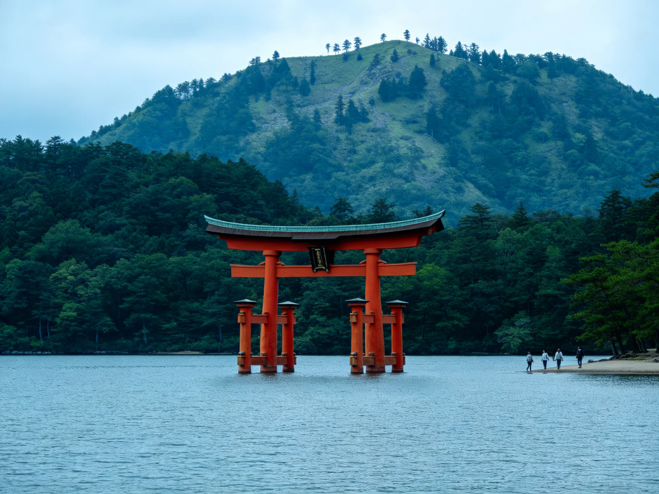 A vibrant red torii gate stands in calm waters near forested hills
