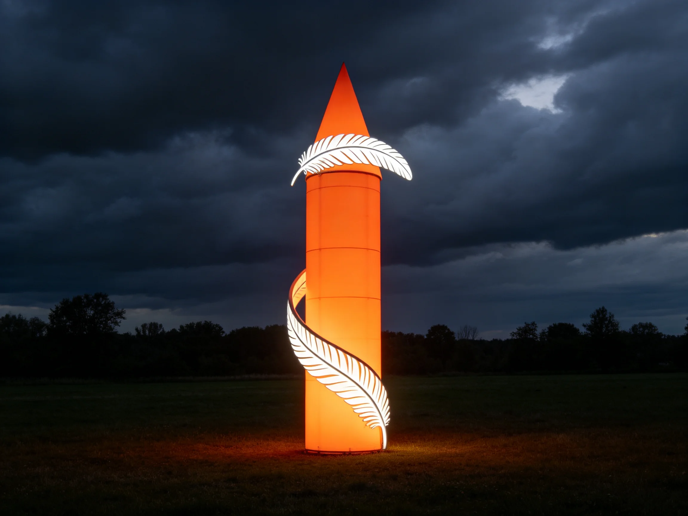 An illuminated orange tower sculpture with white feather art under dark stormy skies