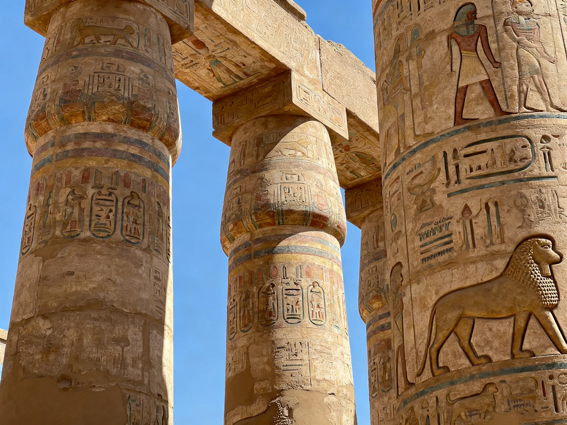Ancient Egyptian temple columns with colorful hieroglyphic carvings
