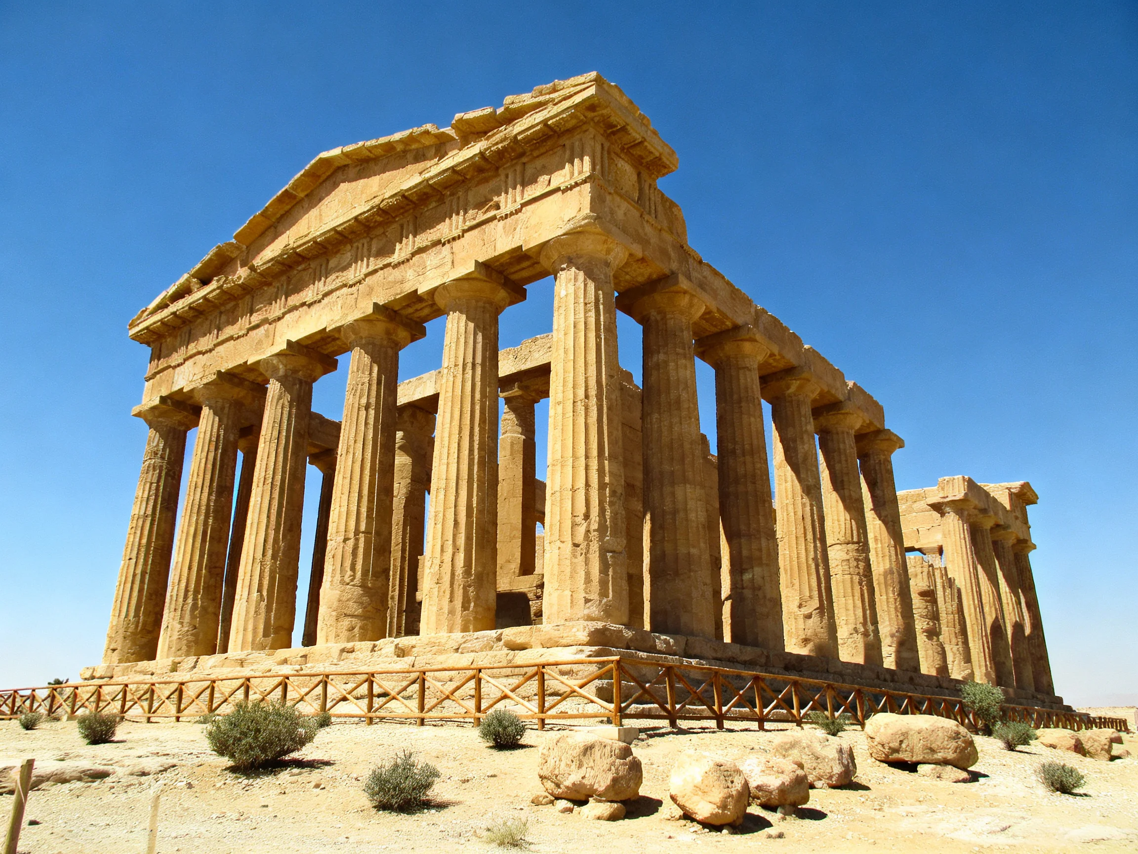 Ancient Greek Temple Ruins with Tall Stone Columns Under Clear Blue Sky