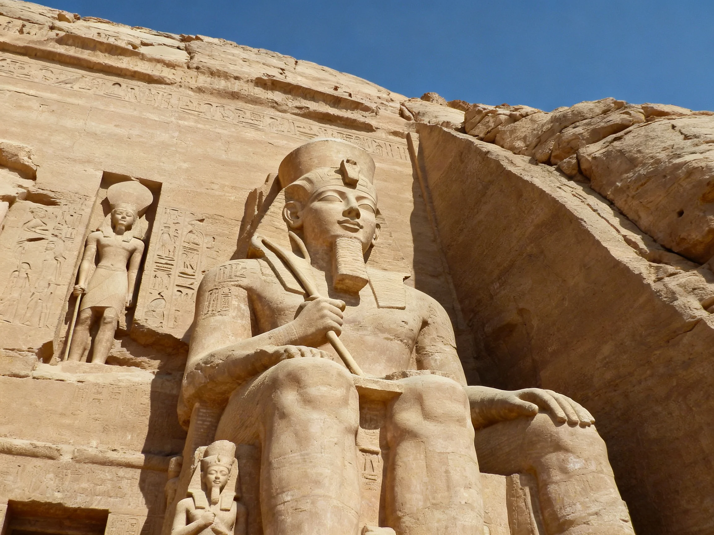 Ancient Sandstone Statues Carved Into Rock Temple Wall