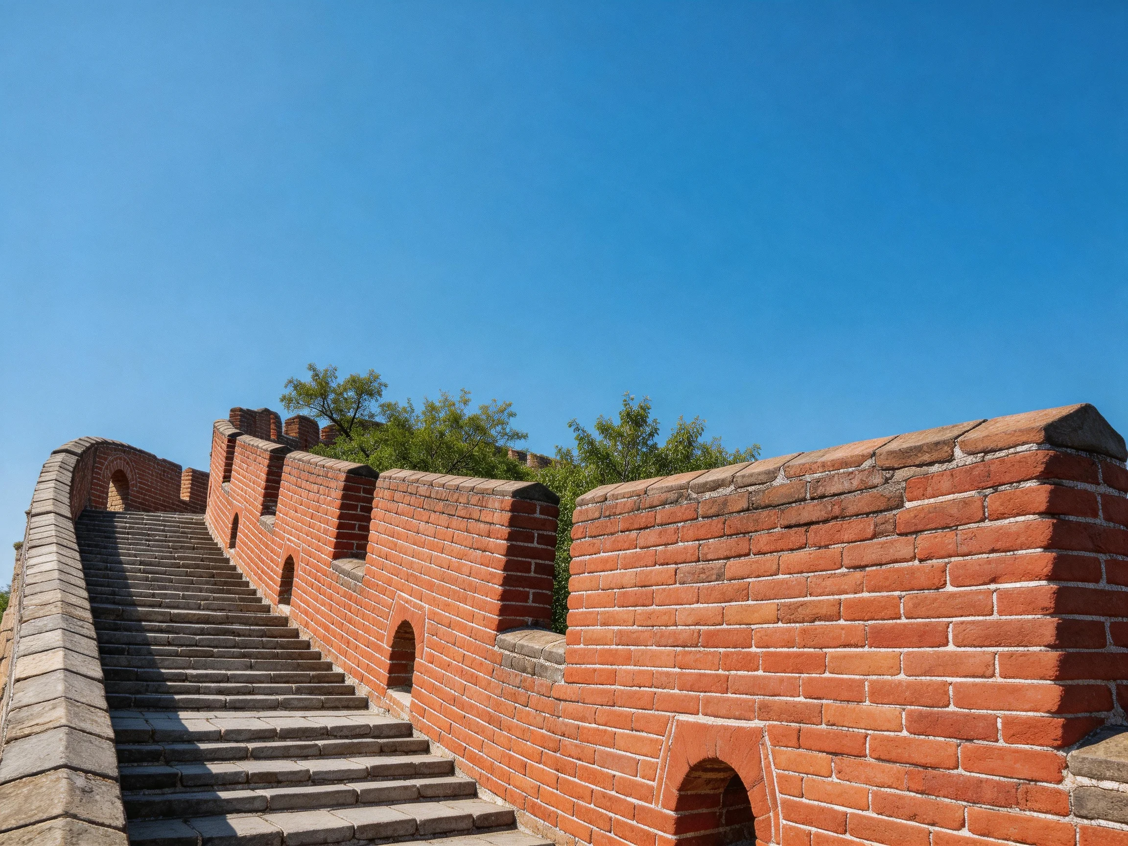 Ancient red-brick wall with stone staircase under clear blue sky