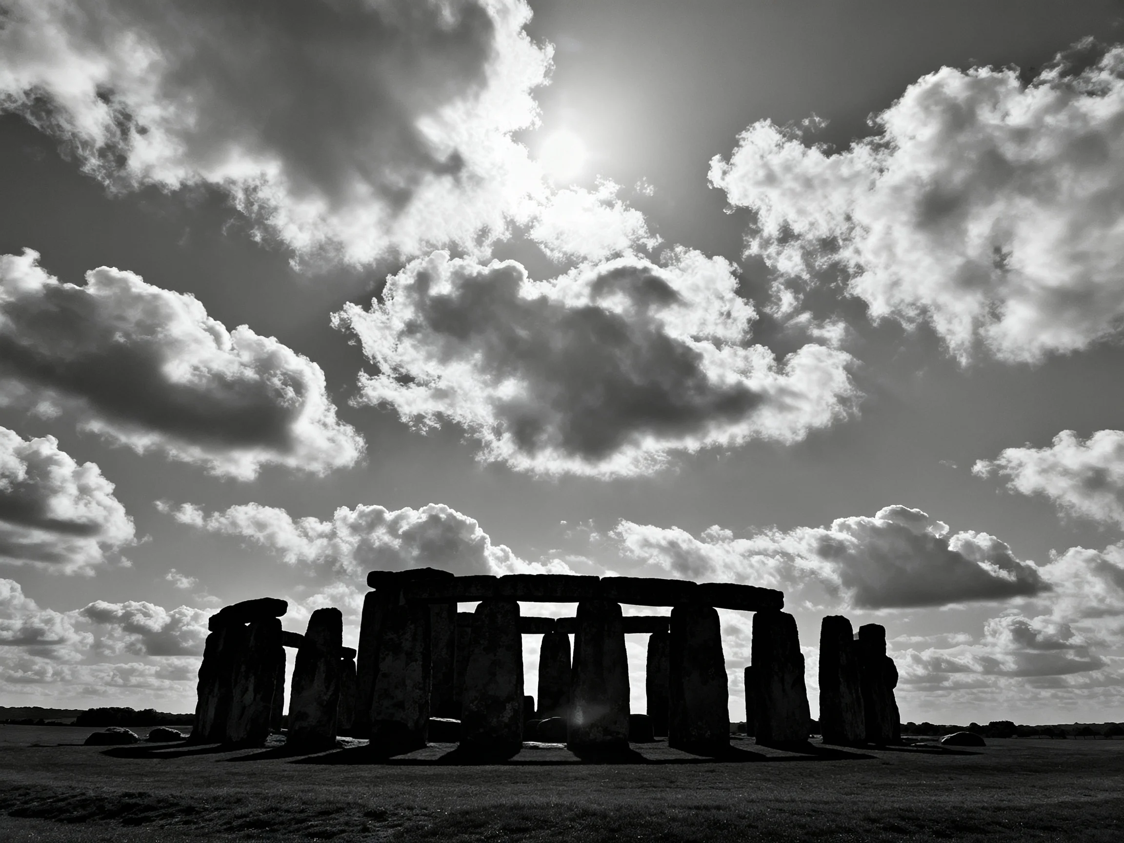 Ancient stone monument silhouetted by dramatic cloudy sky