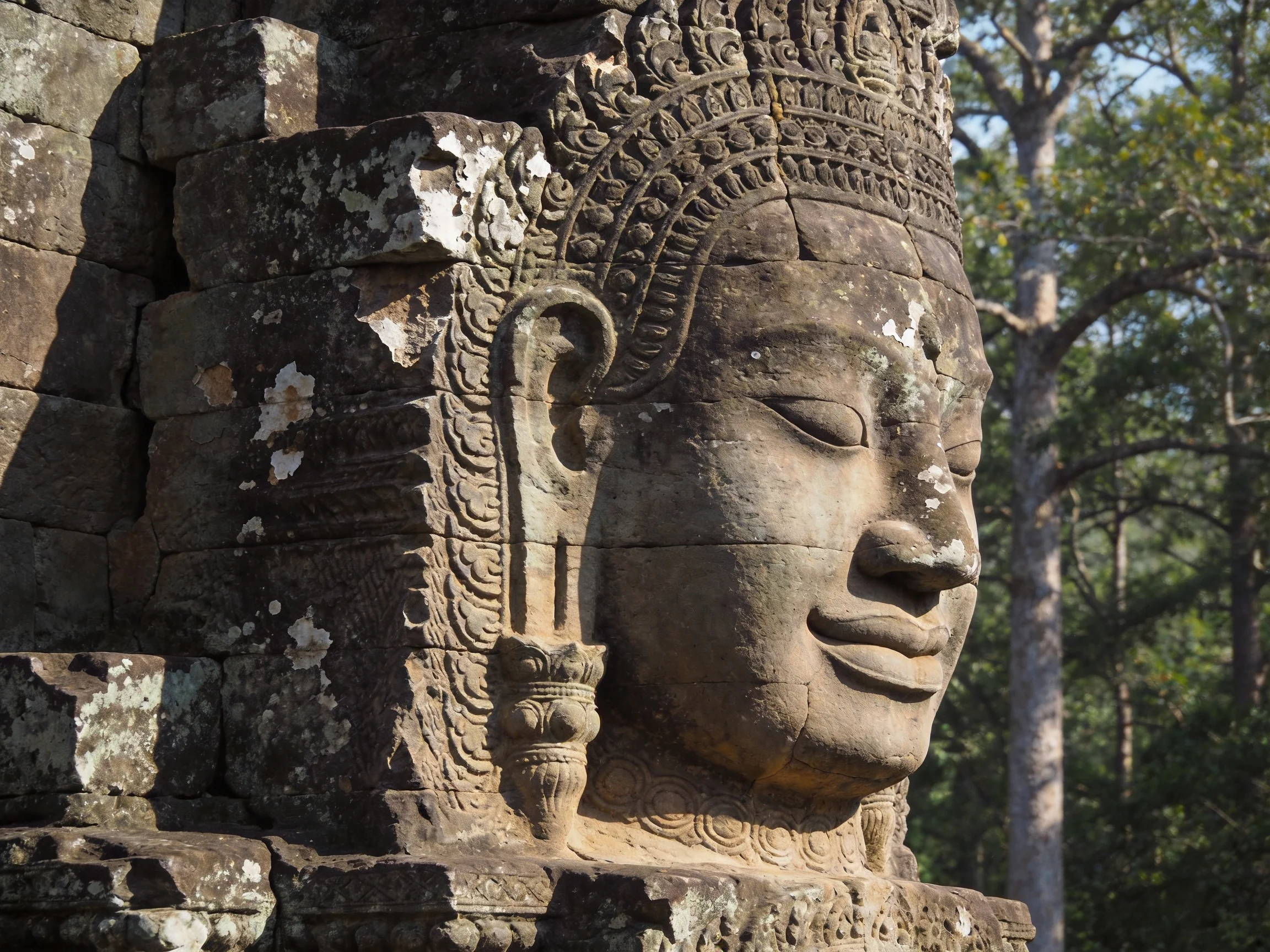 Ancient stone temple carving with ornate details and weathered appearance
