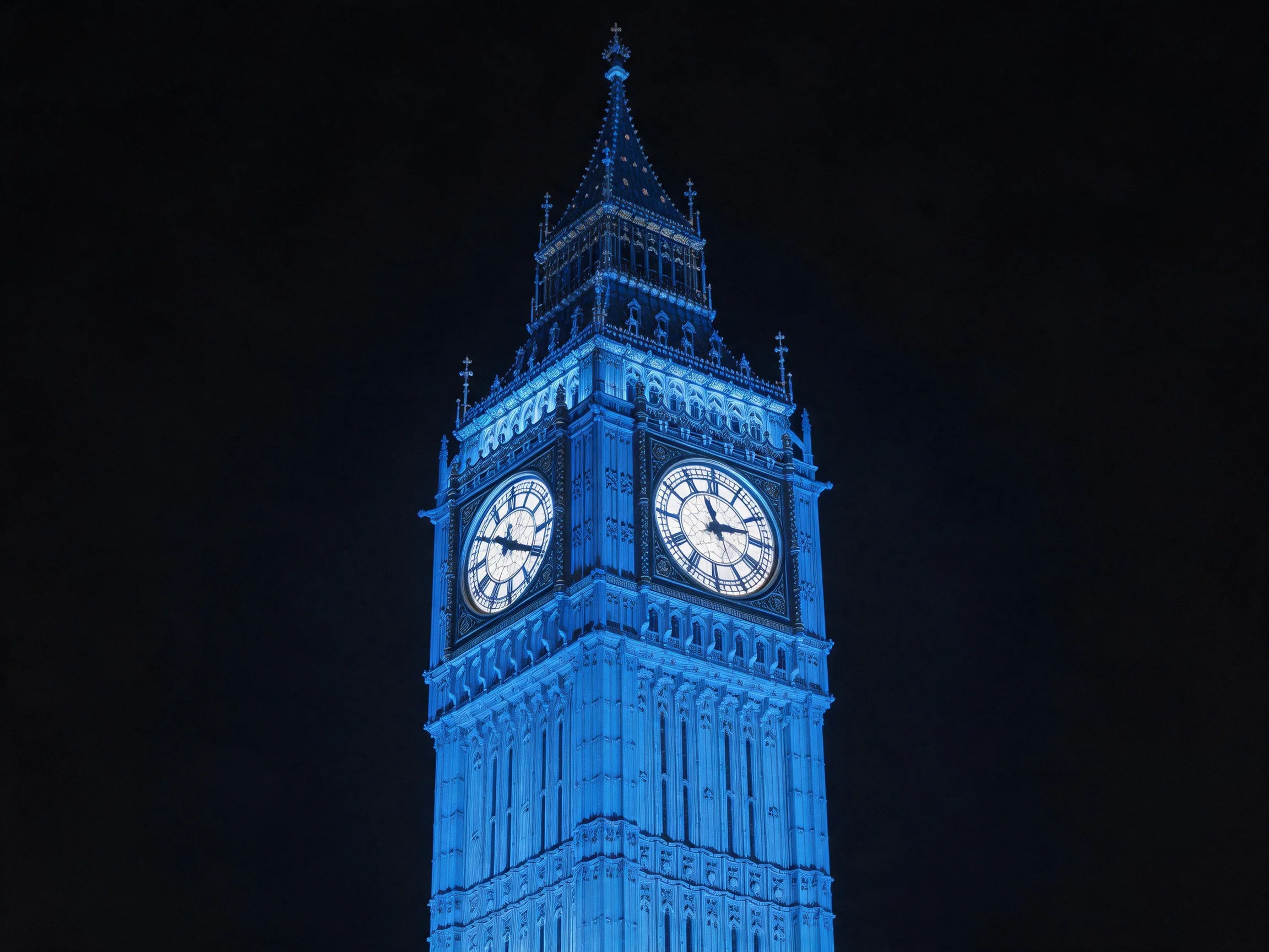 Big Ben illuminated in electric blue against dark night sky