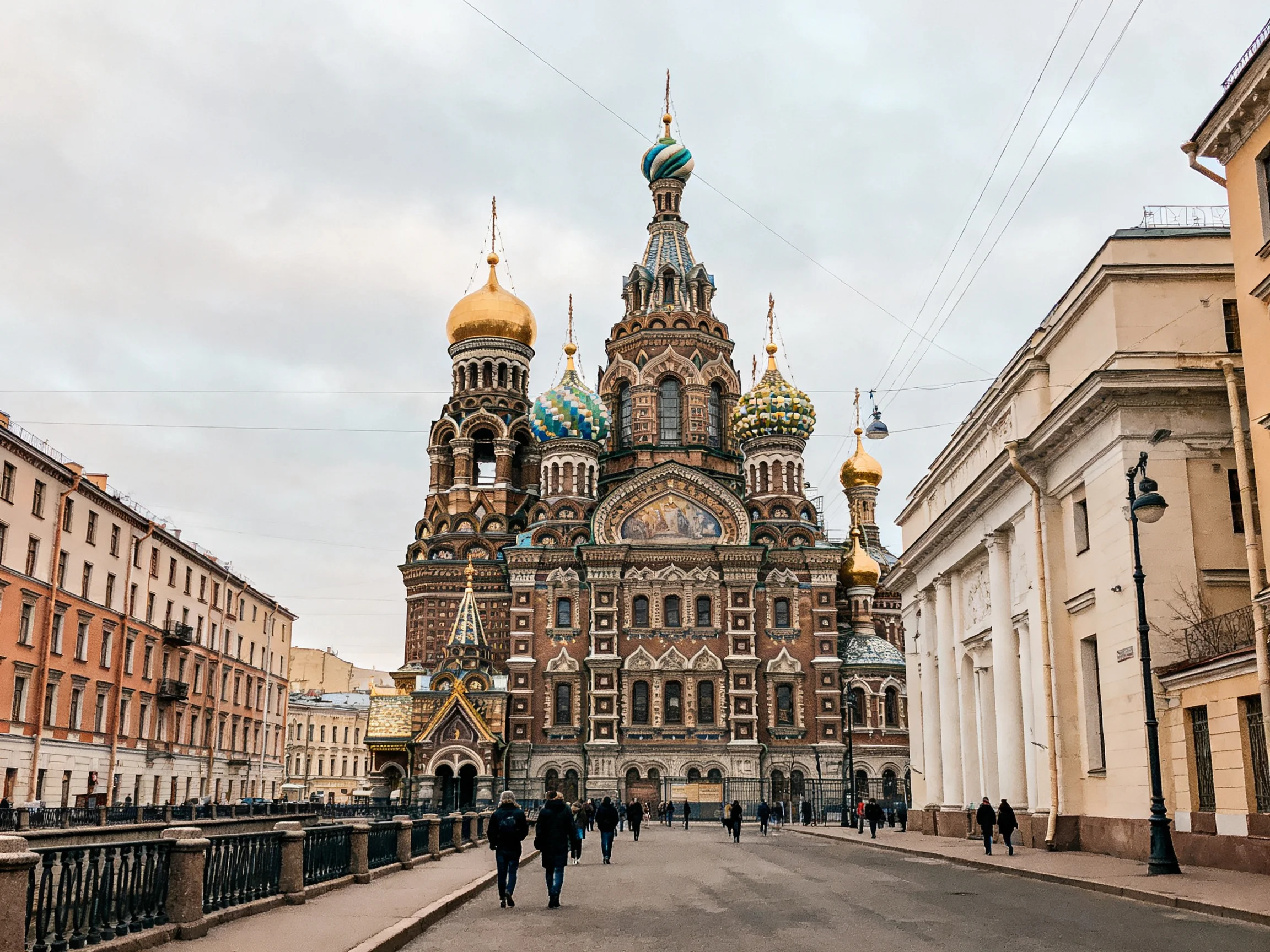 Colorful Russian Orthodox church with golden domes near historic buildings