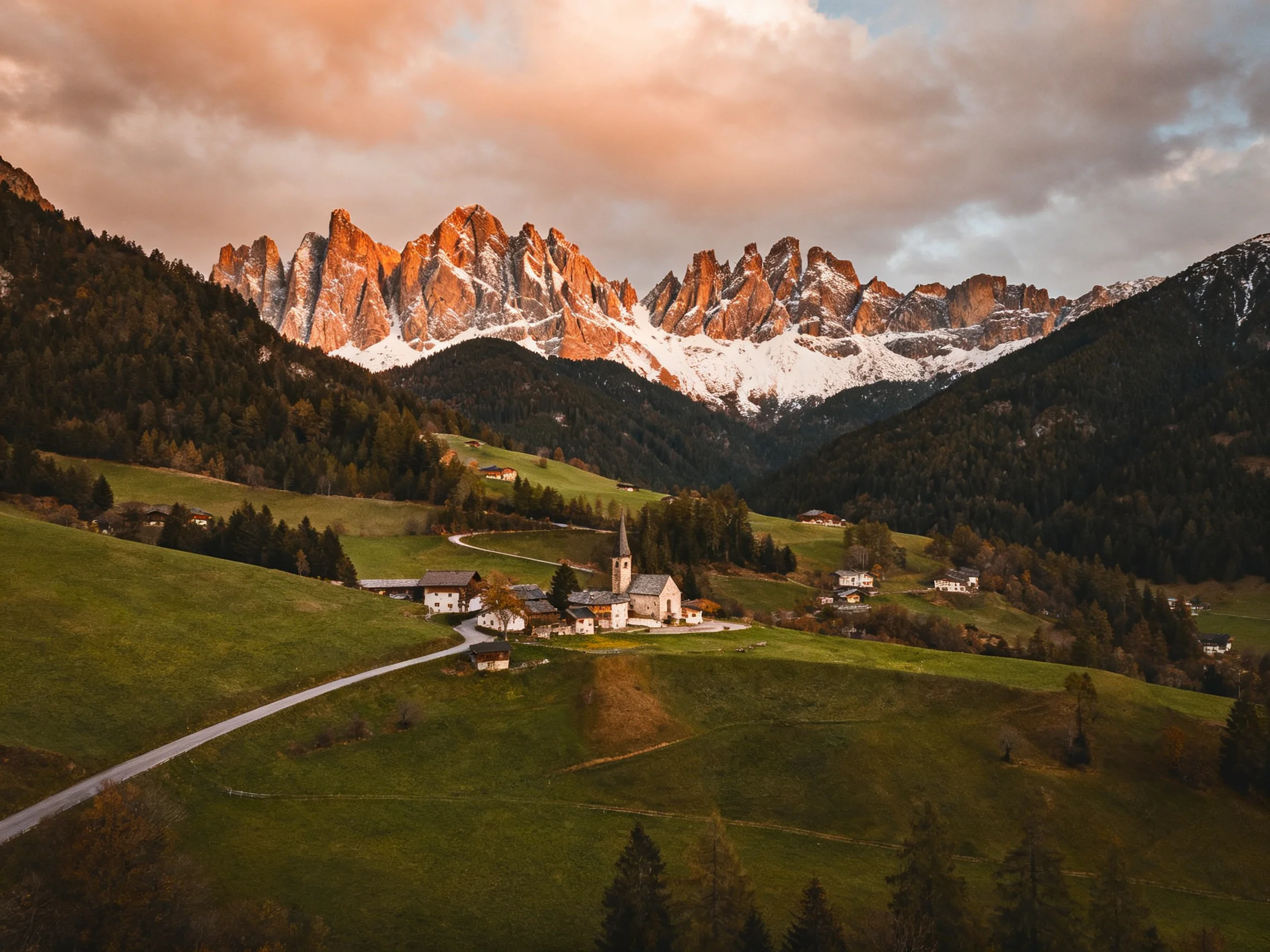 Dramatic mountain peaks illuminate a quaint village below
