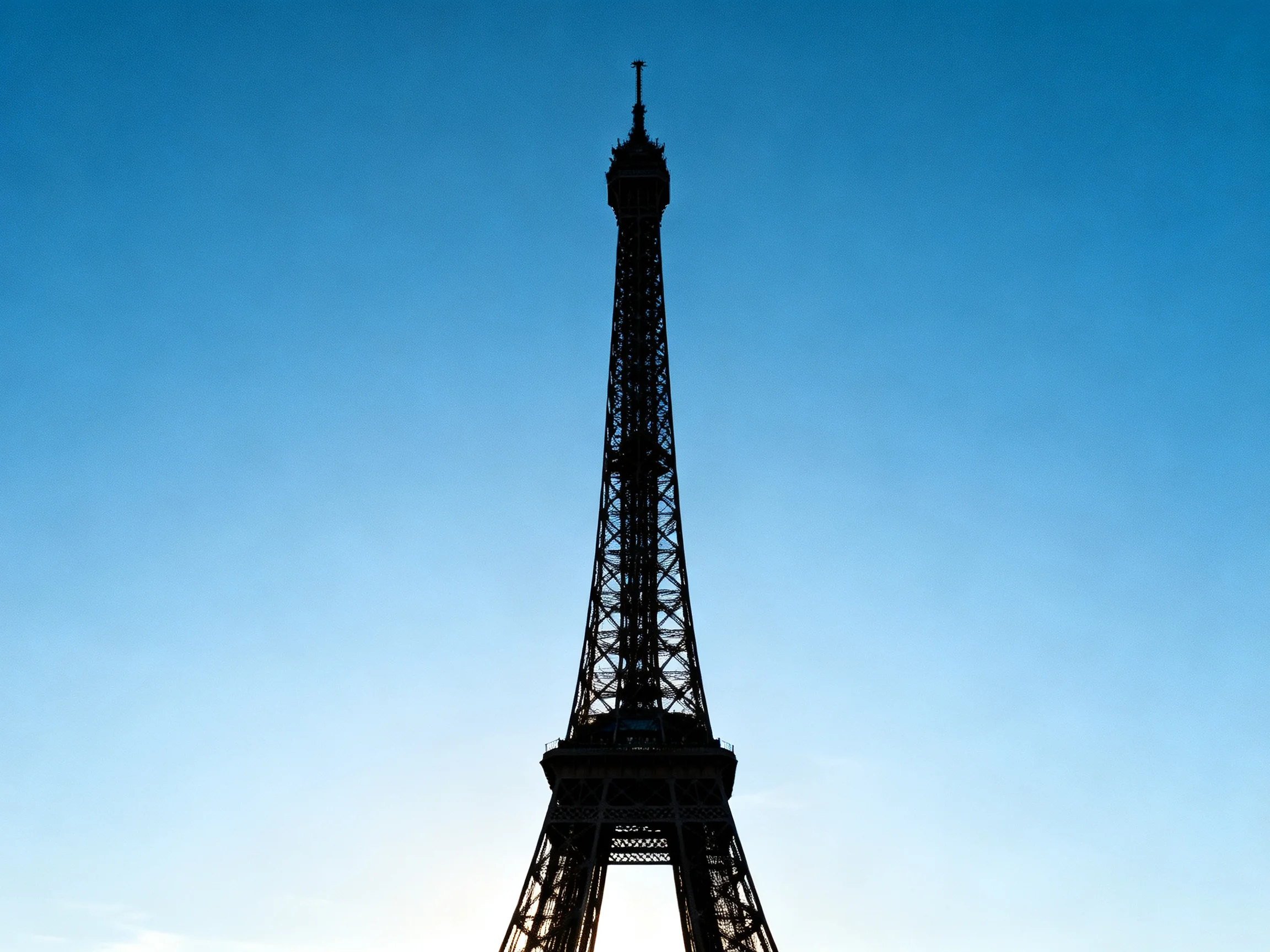 Eiffel Tower Silhouette Against Clear Blue Sky