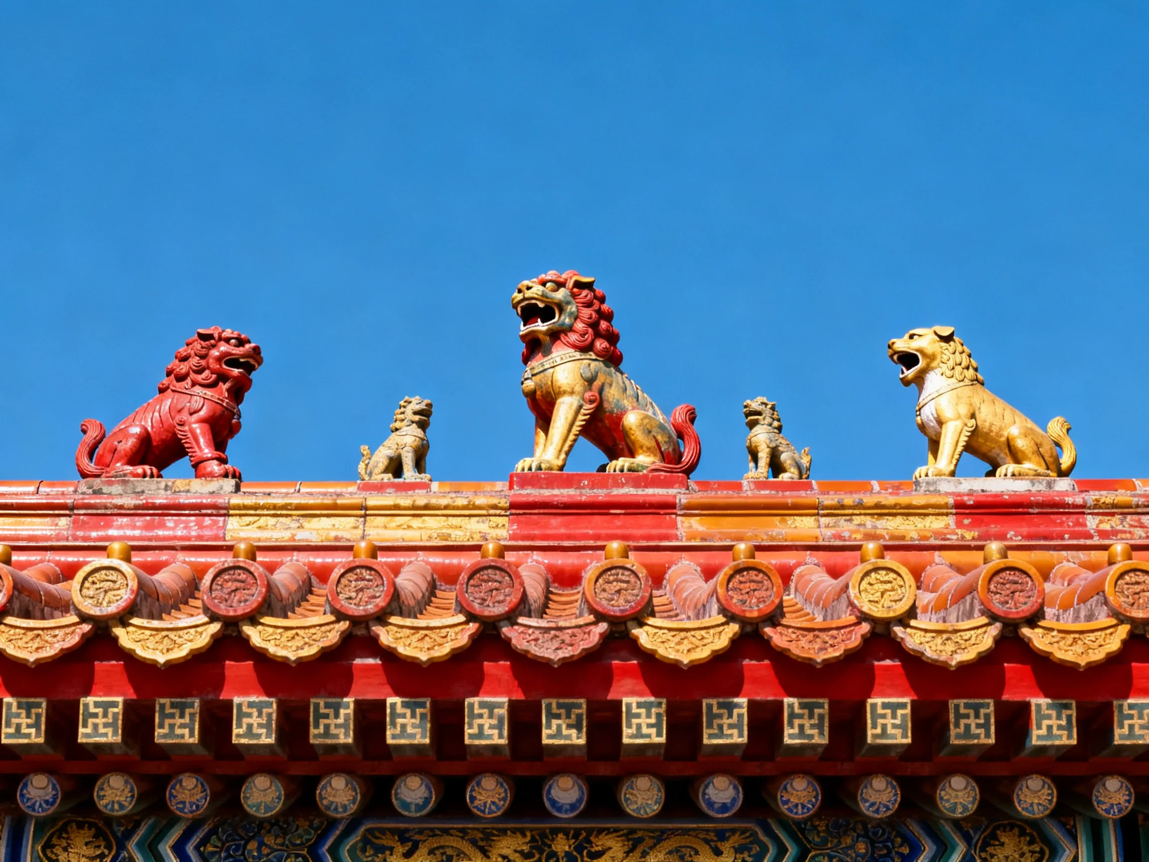 Five colorful lion statues atop an ornately decorated traditional roof