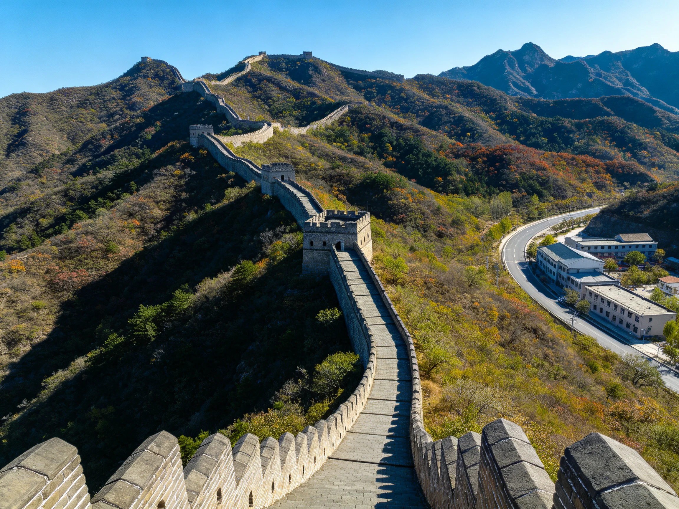 Great Wall winds over mountain ridges with colorful autumn scenery