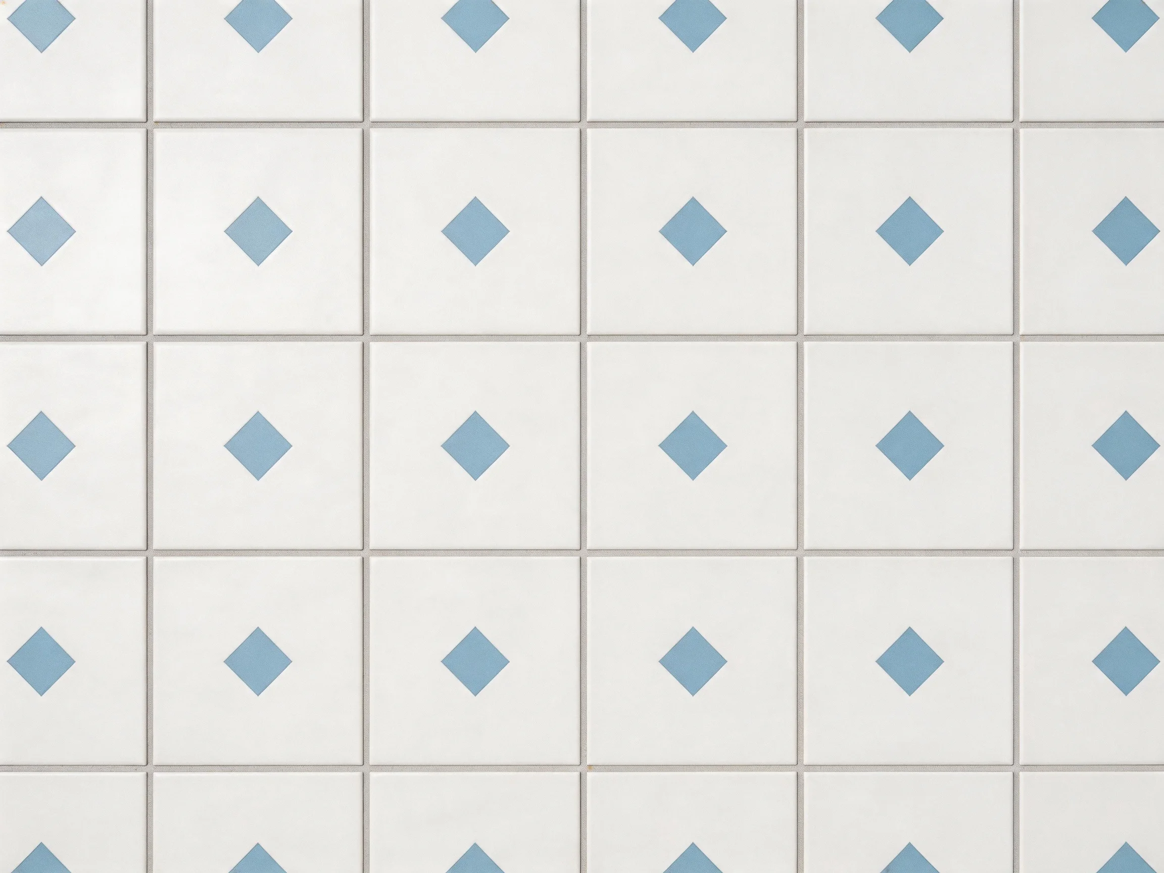 Grid of white tiles with small blue diamond designs