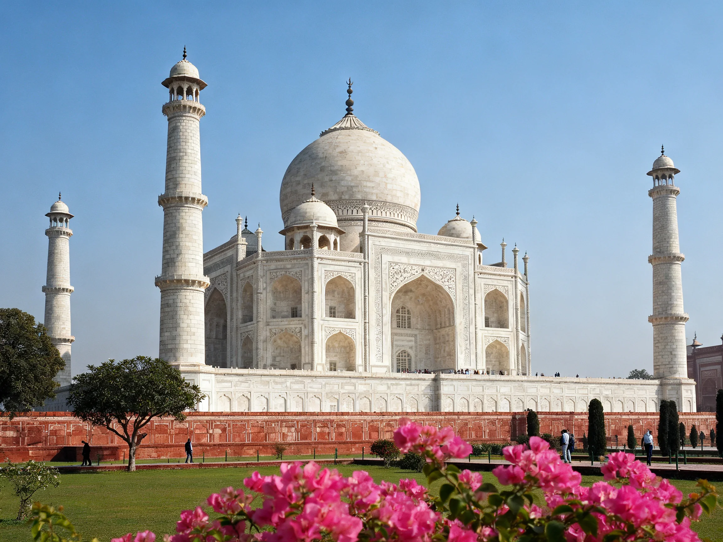 Iconic Taj Mahal with four white minarets and pink blooms