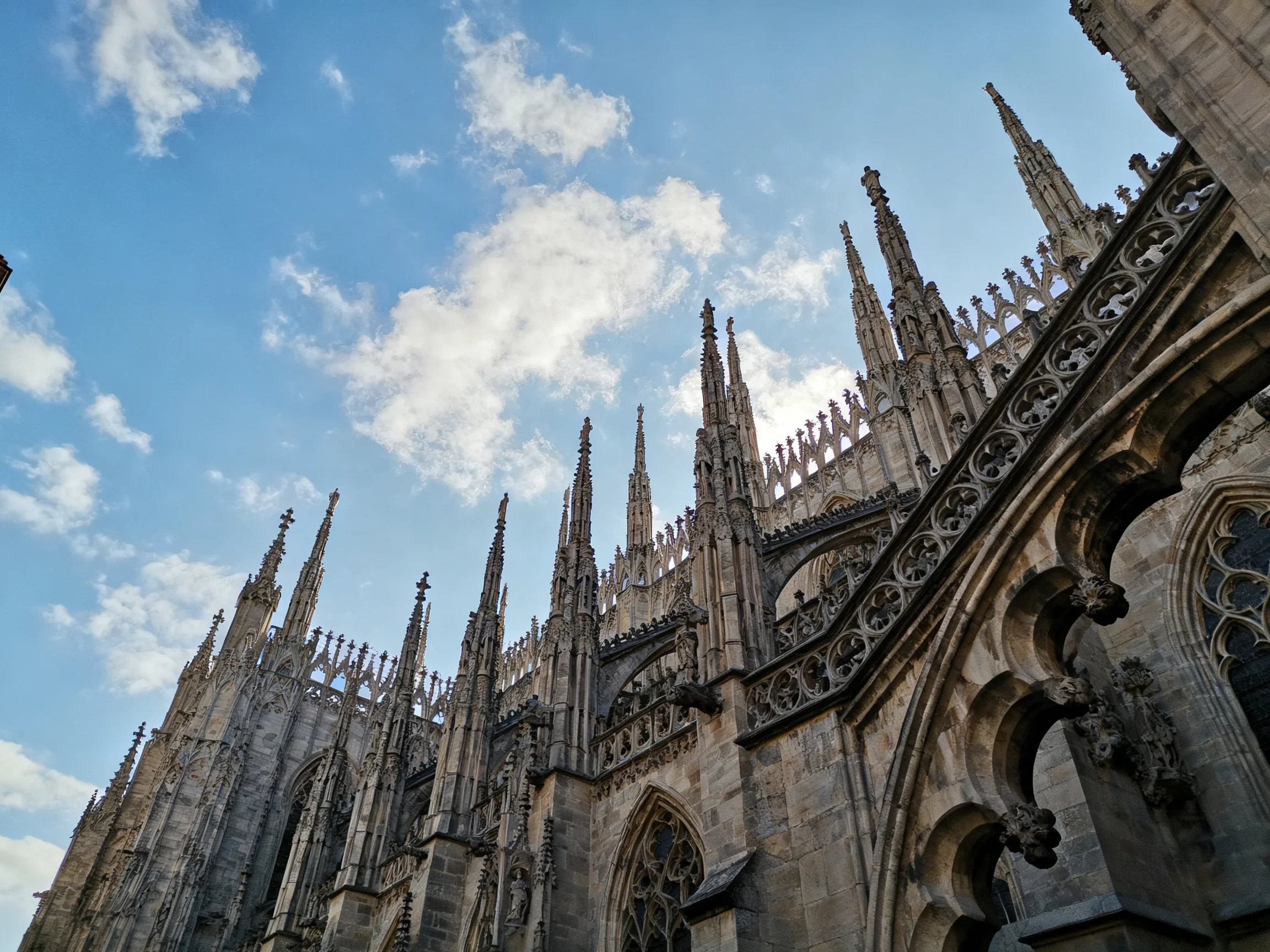 Intricate Gothic Cathedral Spire Detail Against Bright Blue Sky