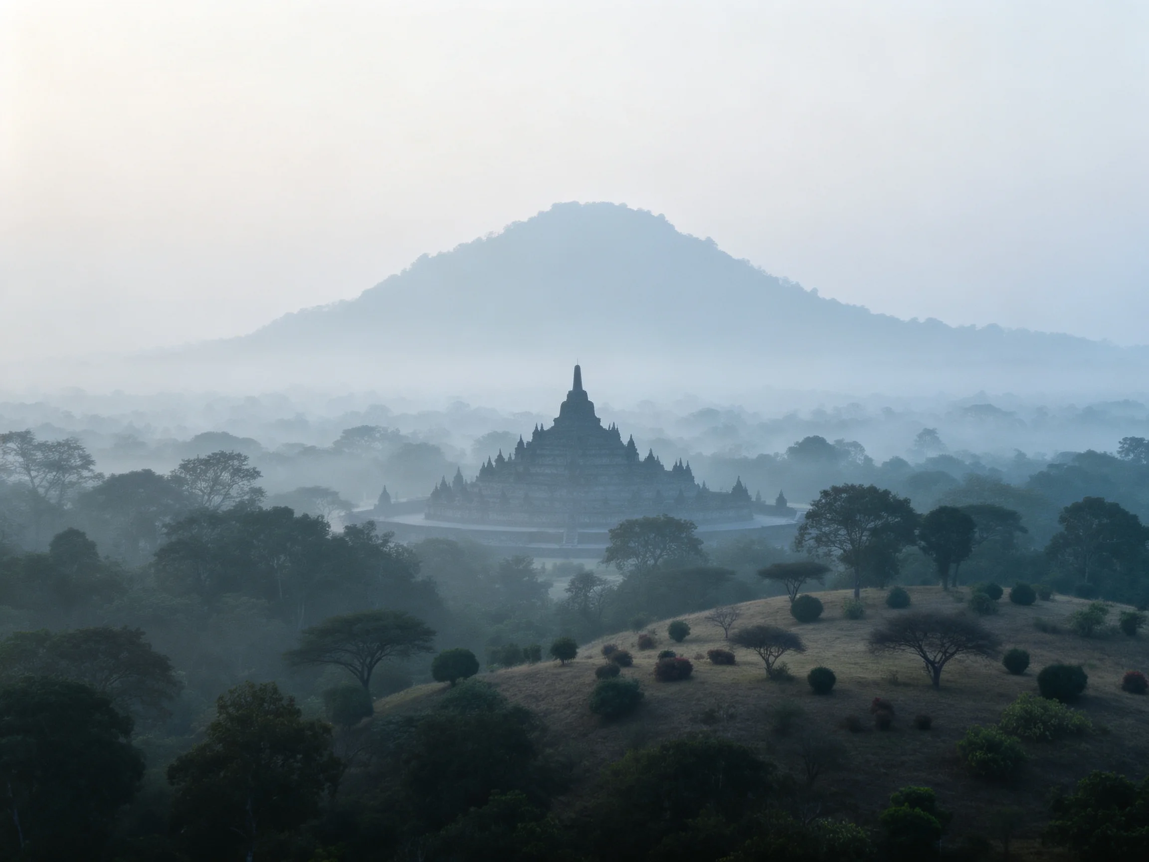 Misty Ancient Temple Complex Surrounded by Lush Forested Hills