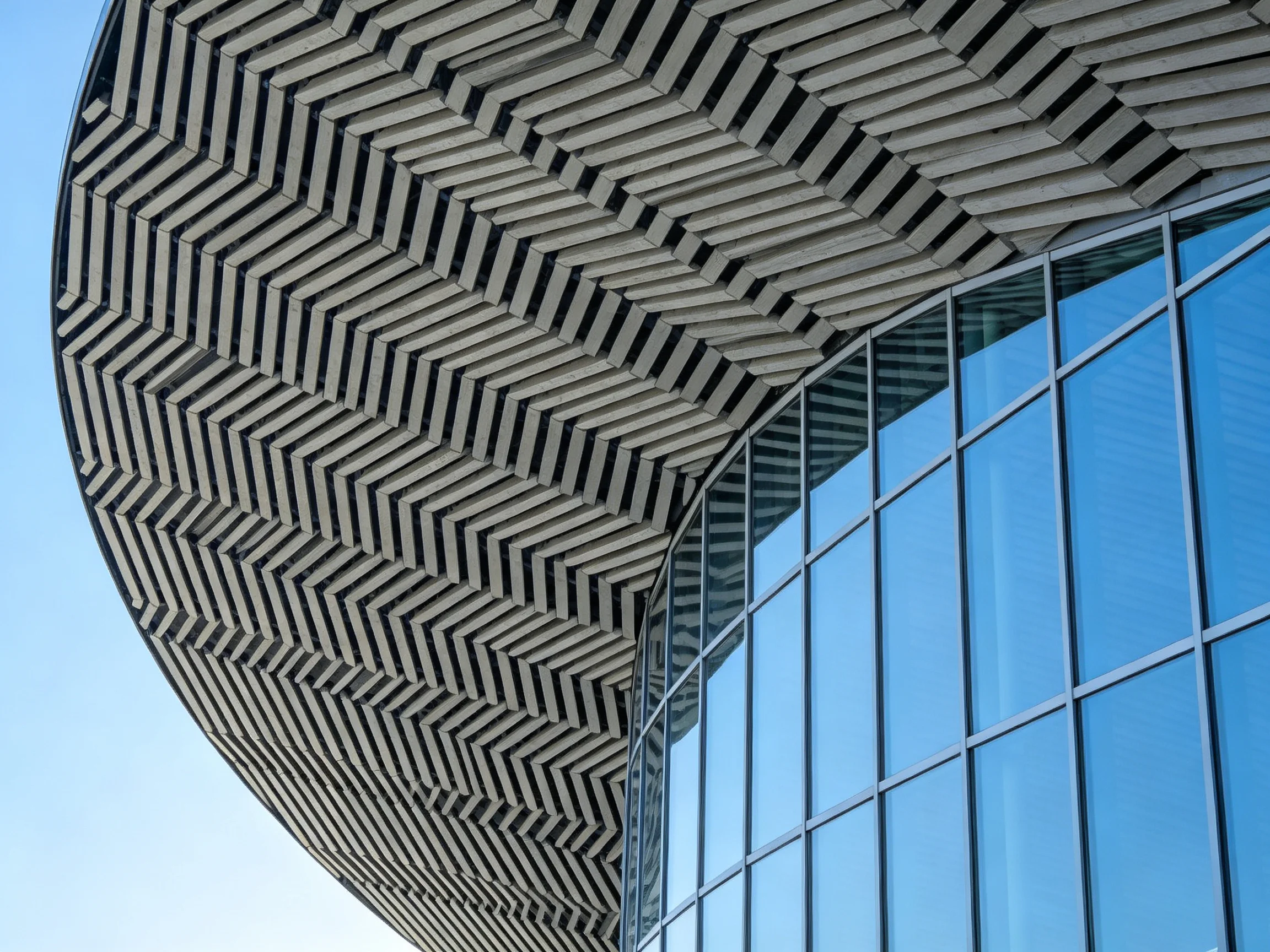 Modern building with zigzag roof and blue glass panels