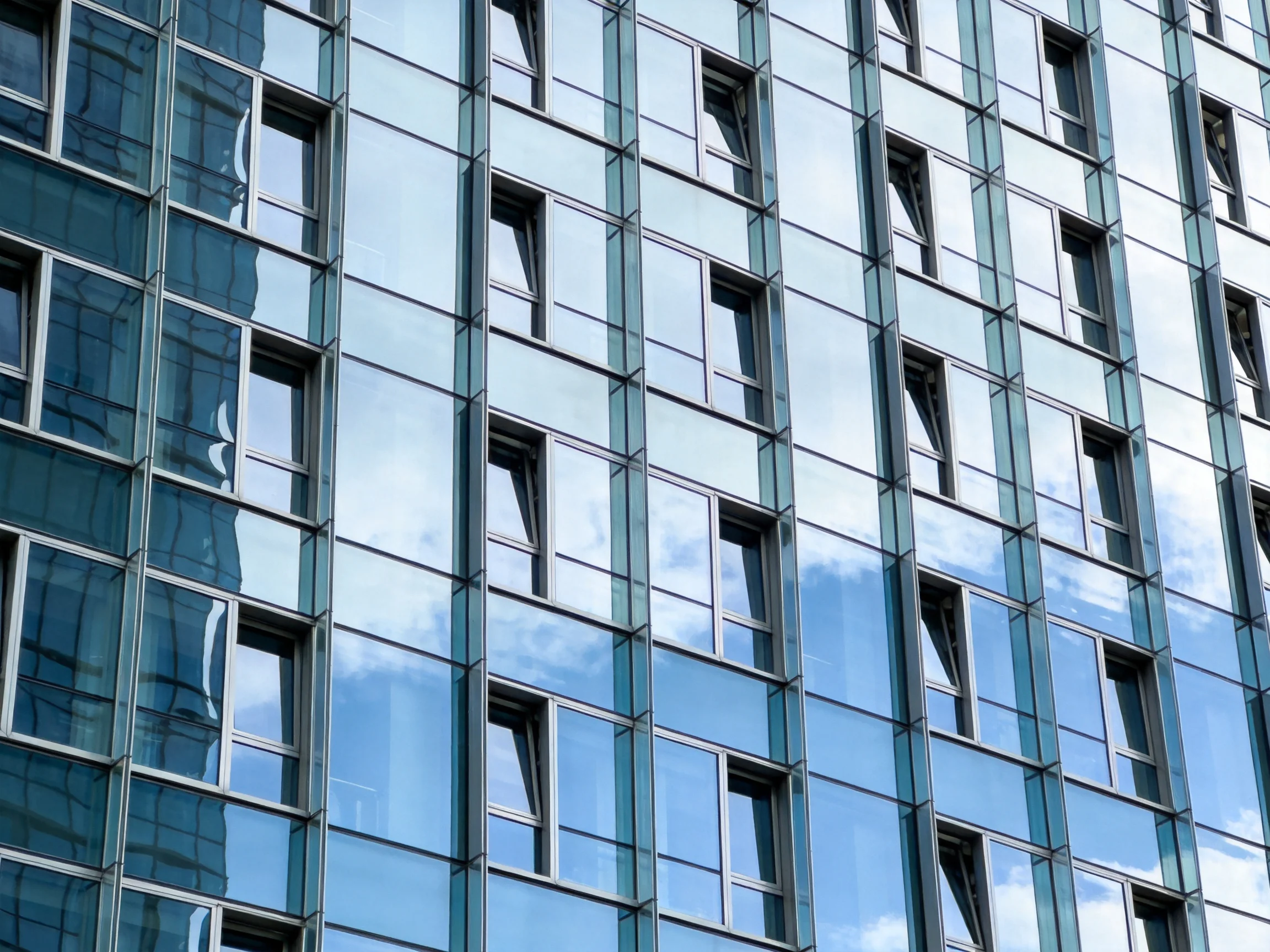 Modern skyscraper facade with blue-tinted glass panels