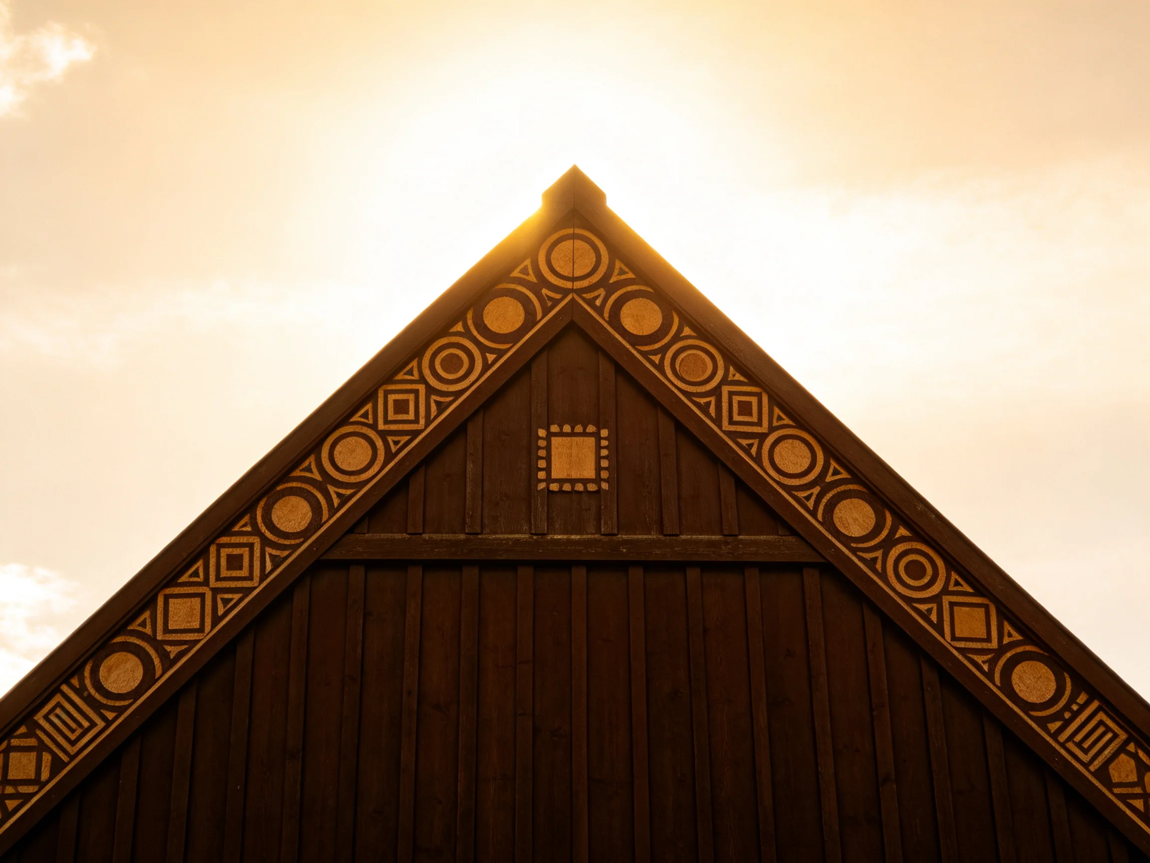 Ornate wooden gable with geometric decorations under golden sunlight