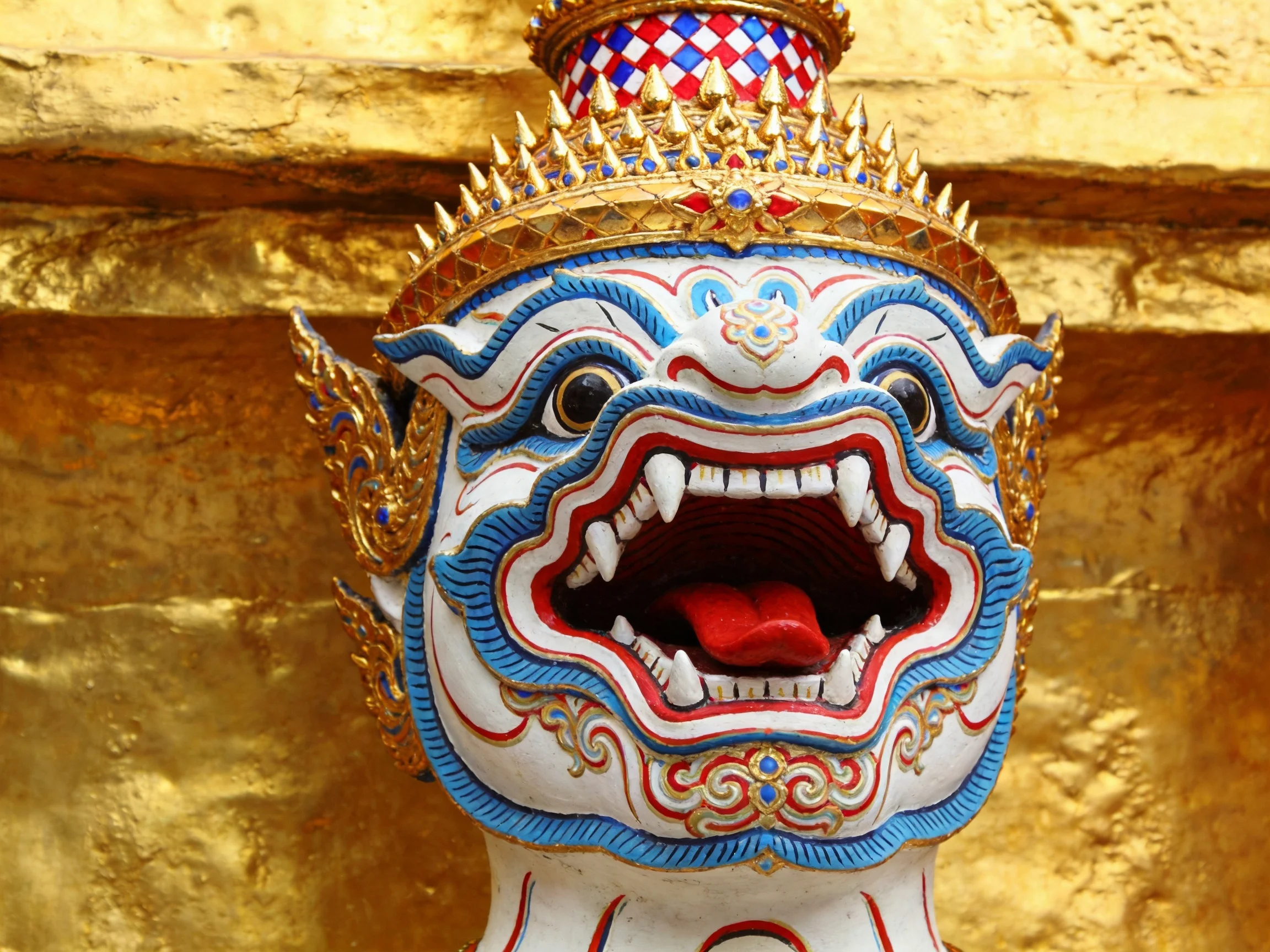 Ornately decorated mythical creature statue with golden crown and blue accents
