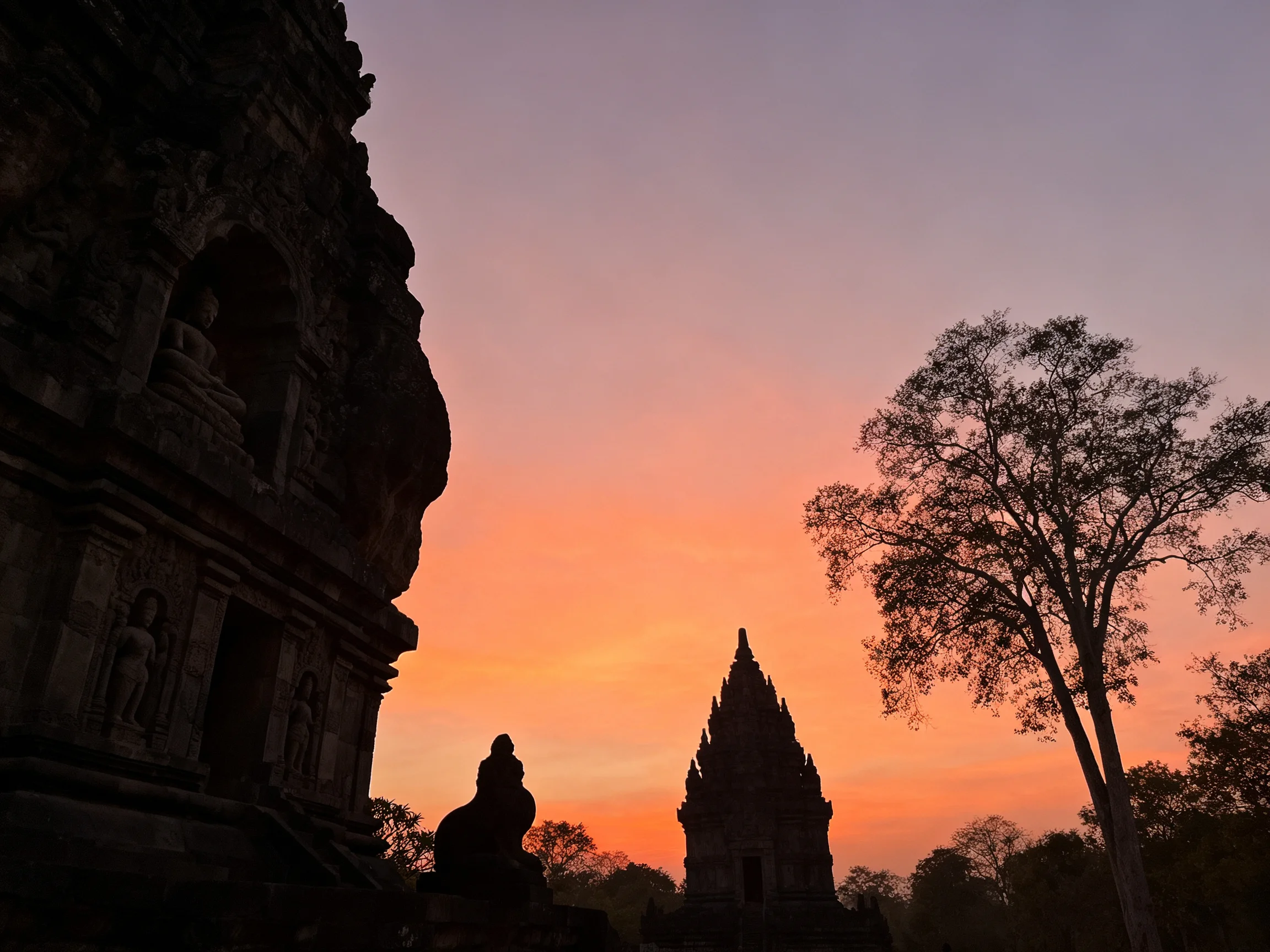 Silhouetted Ancient Temples Under a Vibrant Sunset Sky