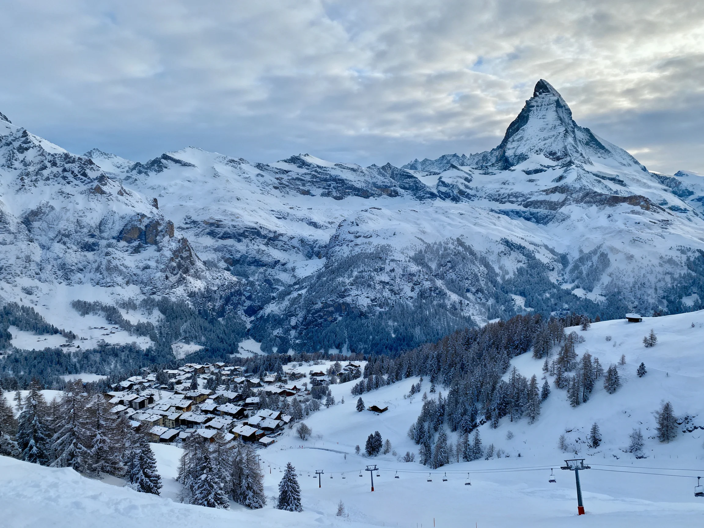 Snow-Covered Matterhorn-Like Peak Overlooking Winter Village