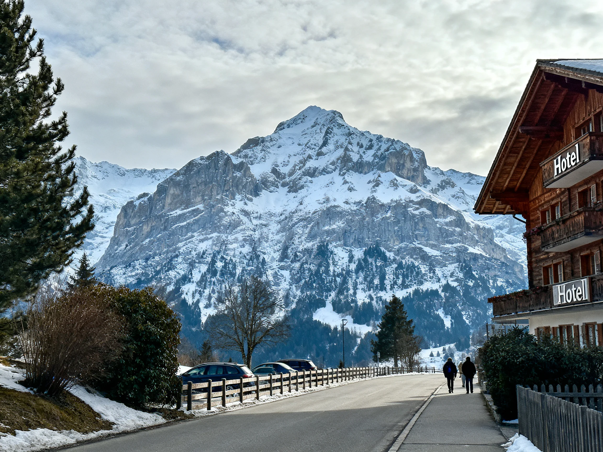 Snow-Covered Mountain Near Wooden Hotel With Pedestrians