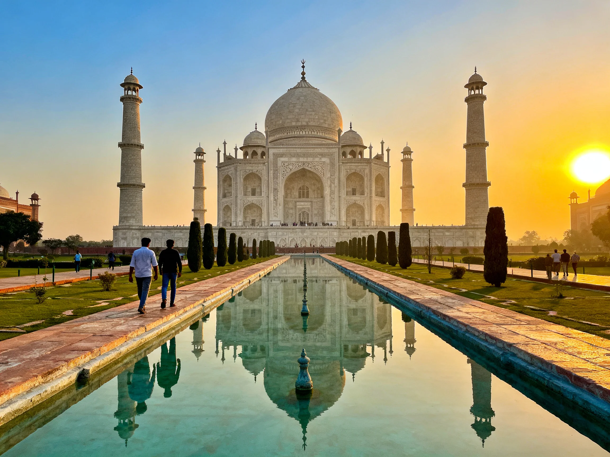 Taj Mahal at Golden Hour with Reflective Waterway and White Marble Structure