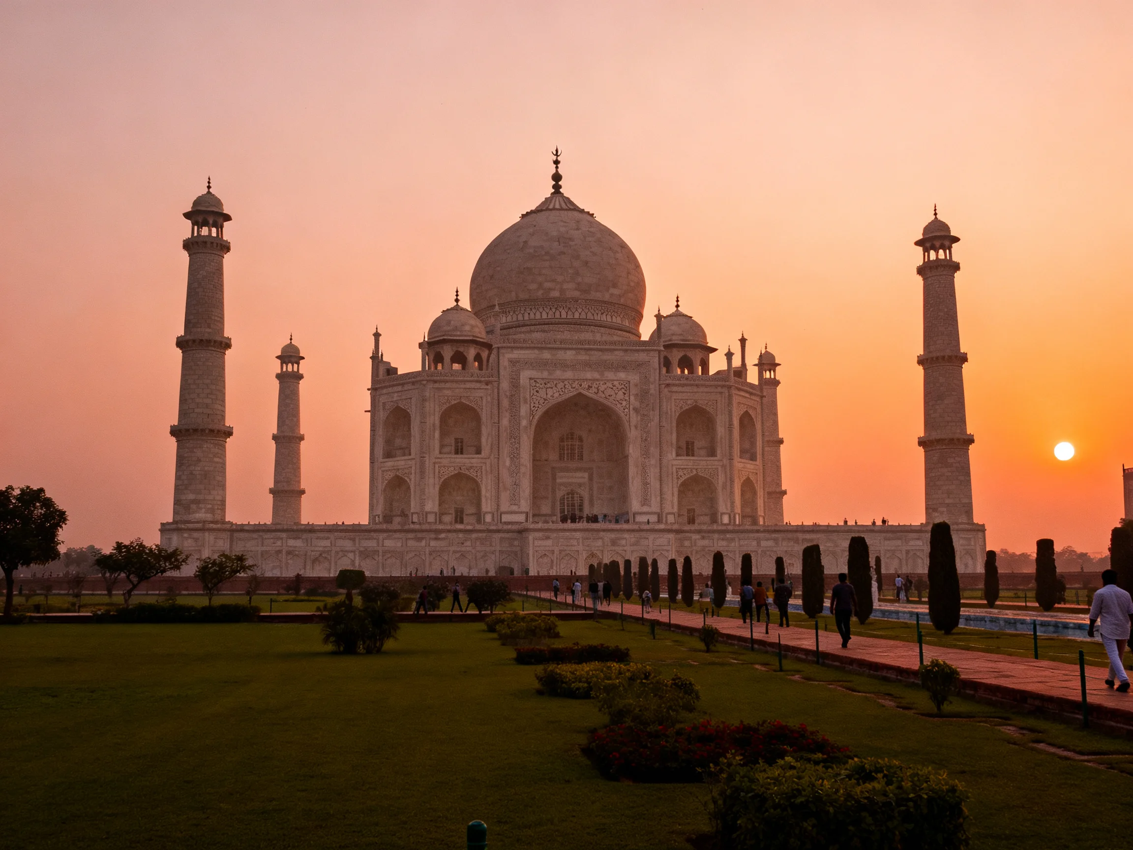 Taj Mahal illuminated by warm orange sunset sky