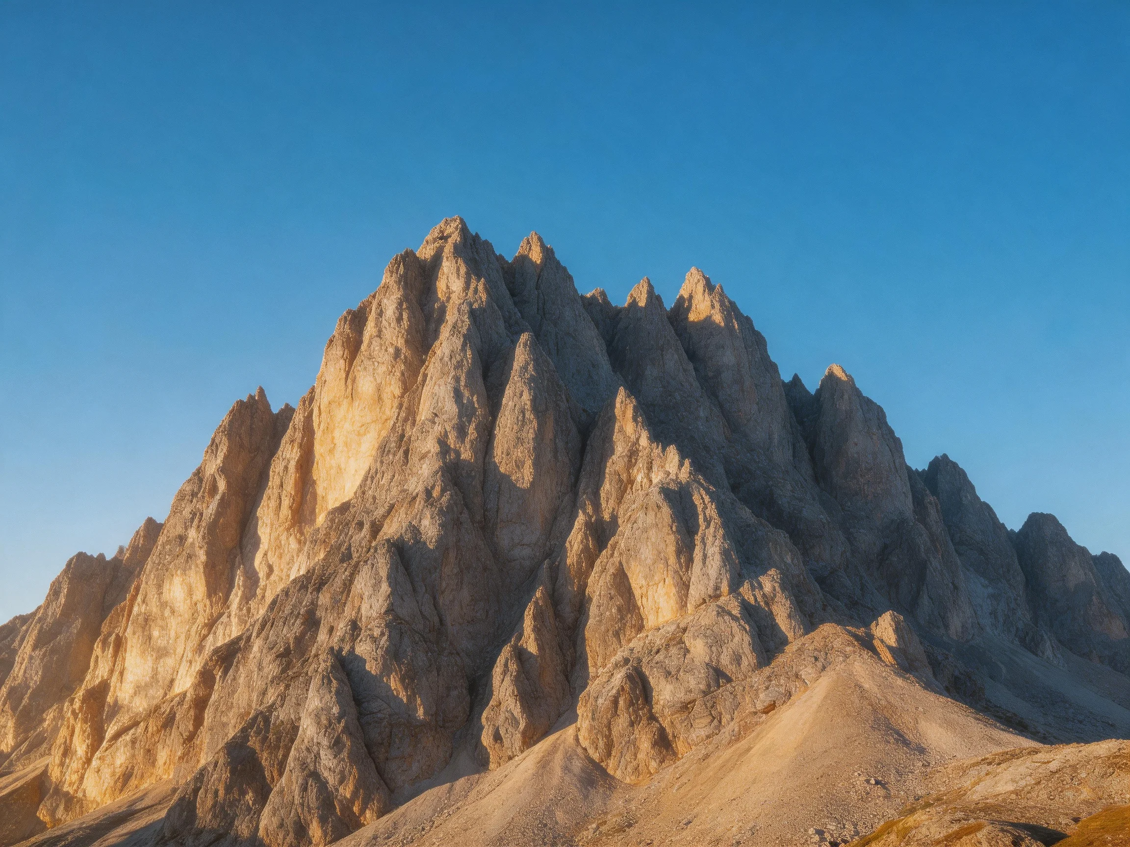 Tall jagged rock formations rise under a vivid blue sky
