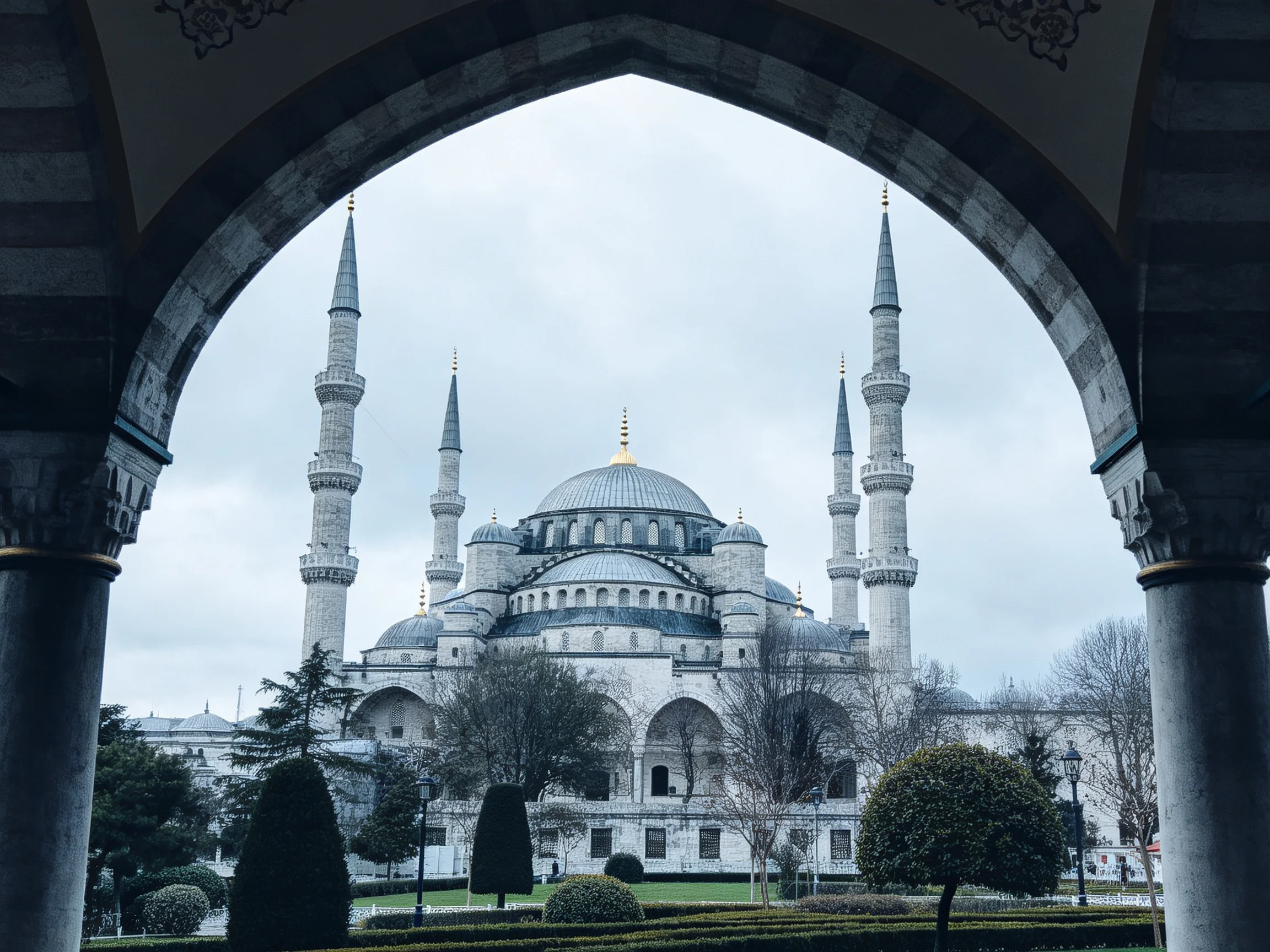 The Blue Mosque viewed through an ornate stone archway with minarets
