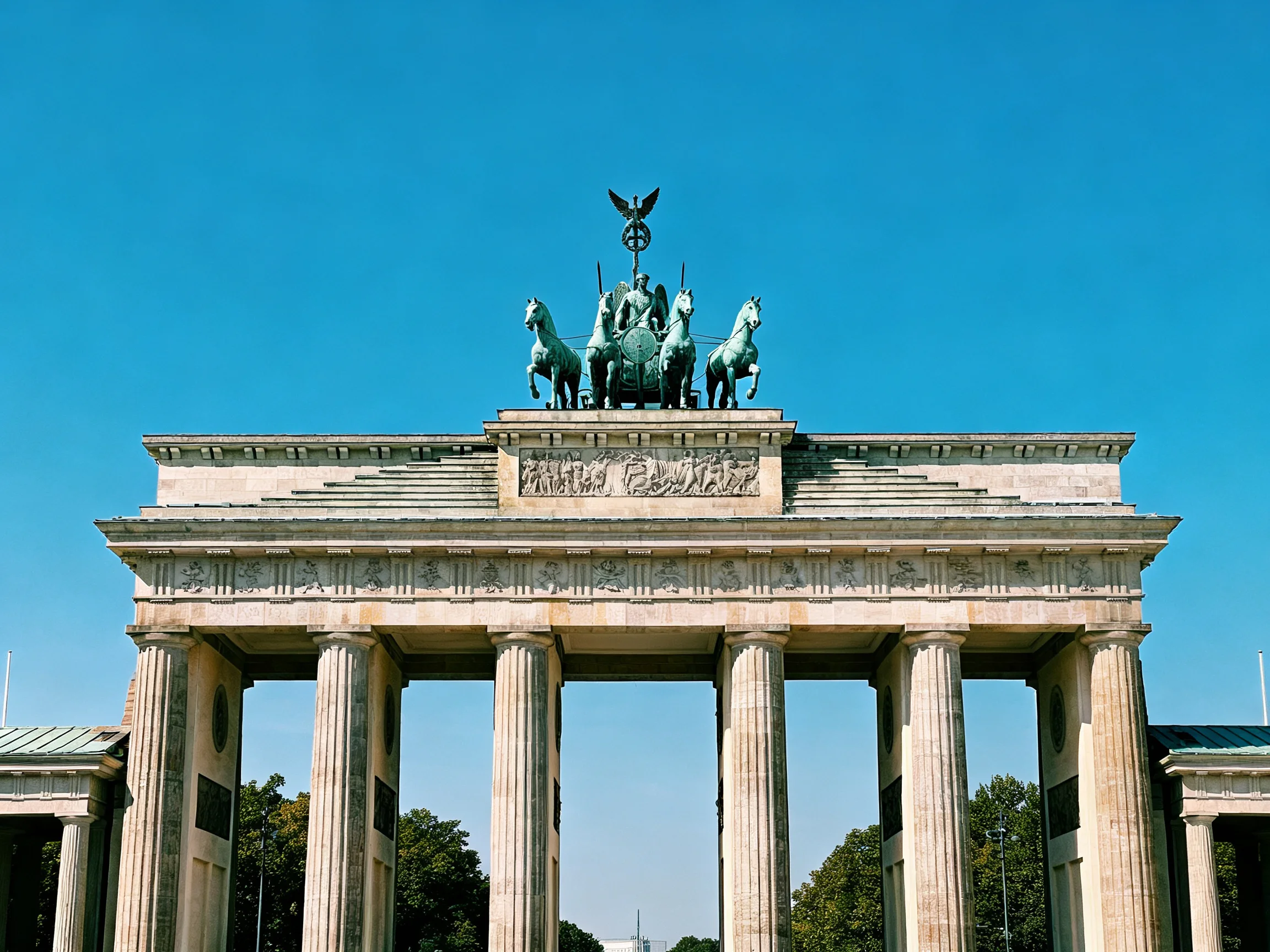 The Brandenburg Gate with Four Horse Sculptures Under a Clear Blue Sky