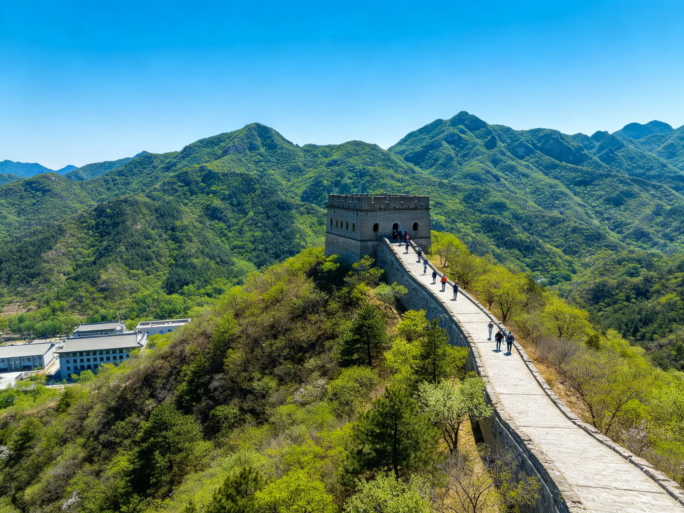 The Great Wall winds through verdant mountains with a stone watchtower