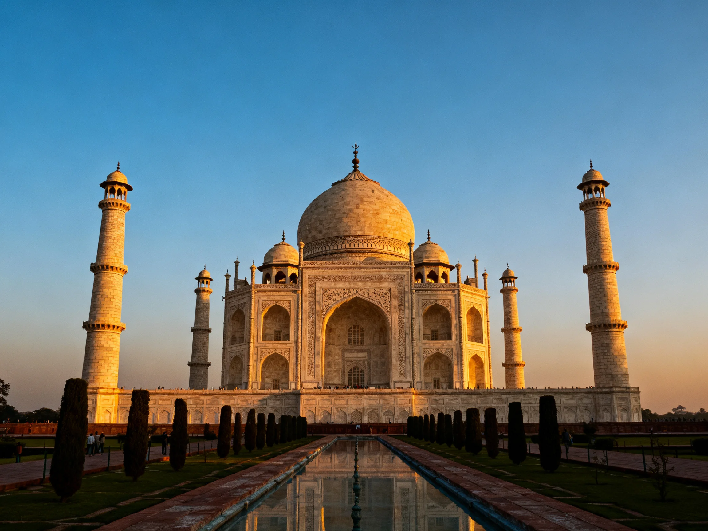 The Taj Mahal bathed in golden light with white marble exterior