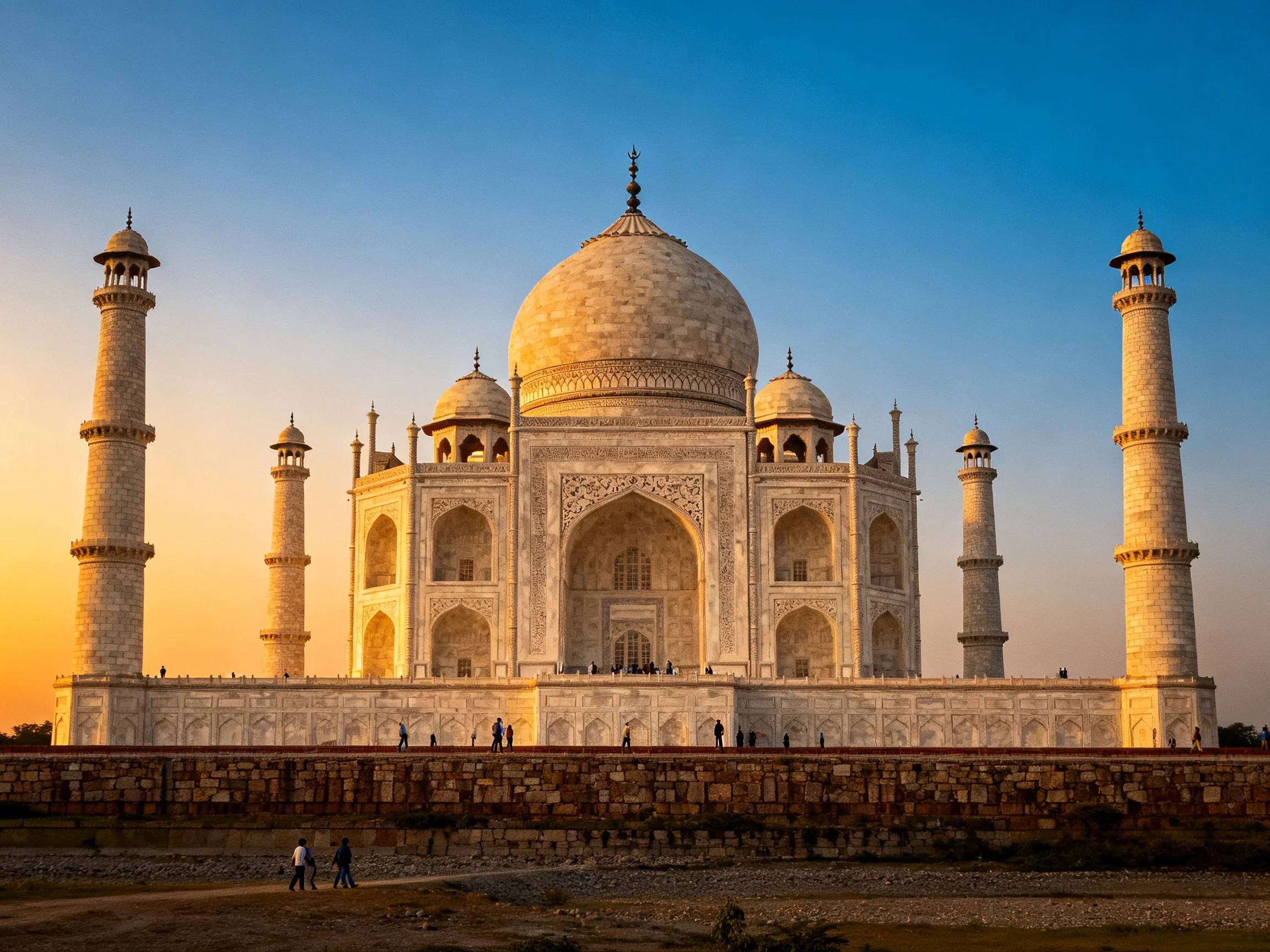 The Taj Mahal glowing in golden light with white marble and blue sky