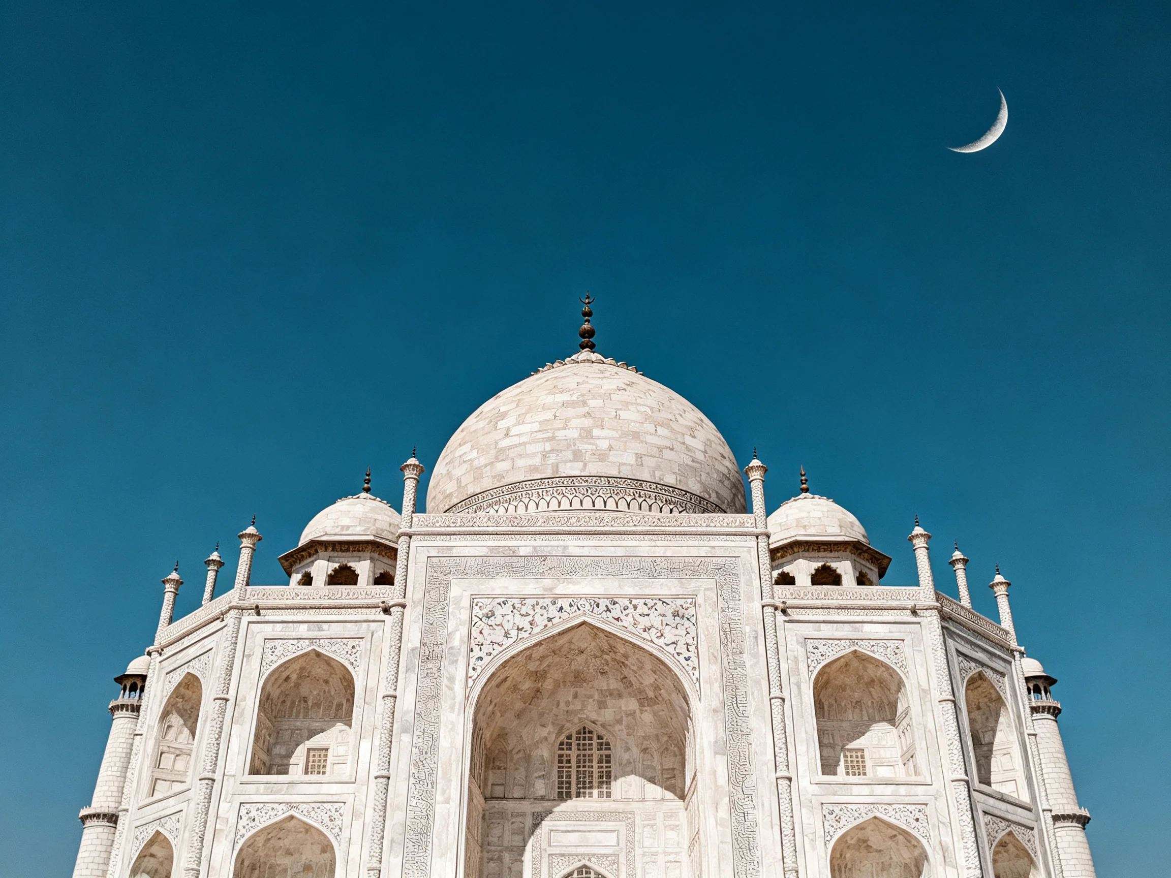 The Taj Mahals White Marble Structure Against a Deep Blue Sky with a Crescent Moon