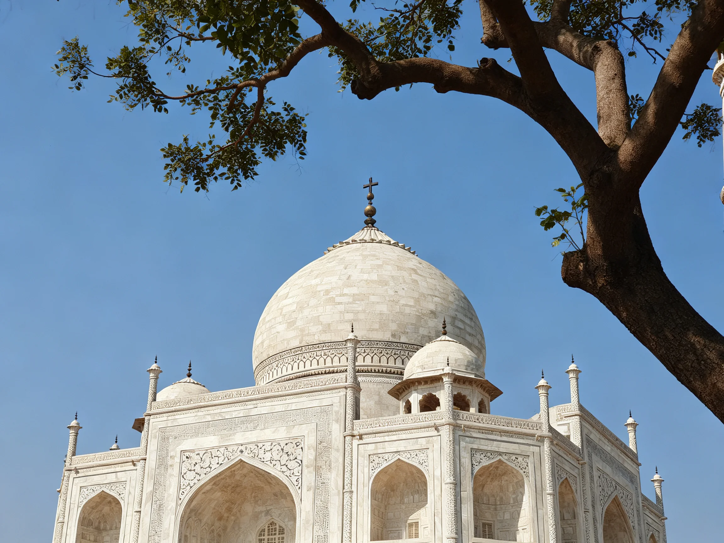 The Taj Mahals ornate white marble dome beneath clear blue sky