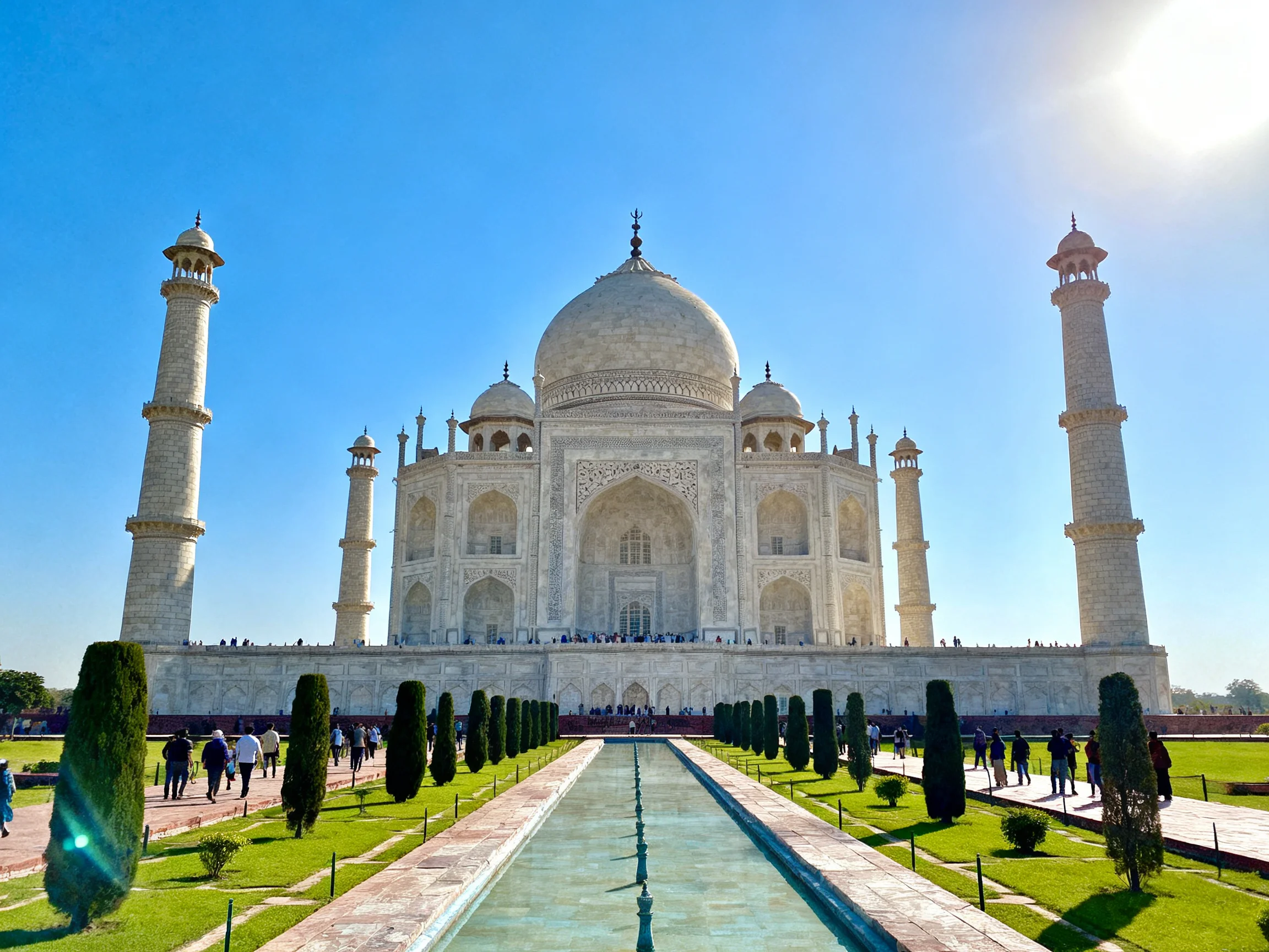 The Taj Mahals white marble dome under clear blue sky