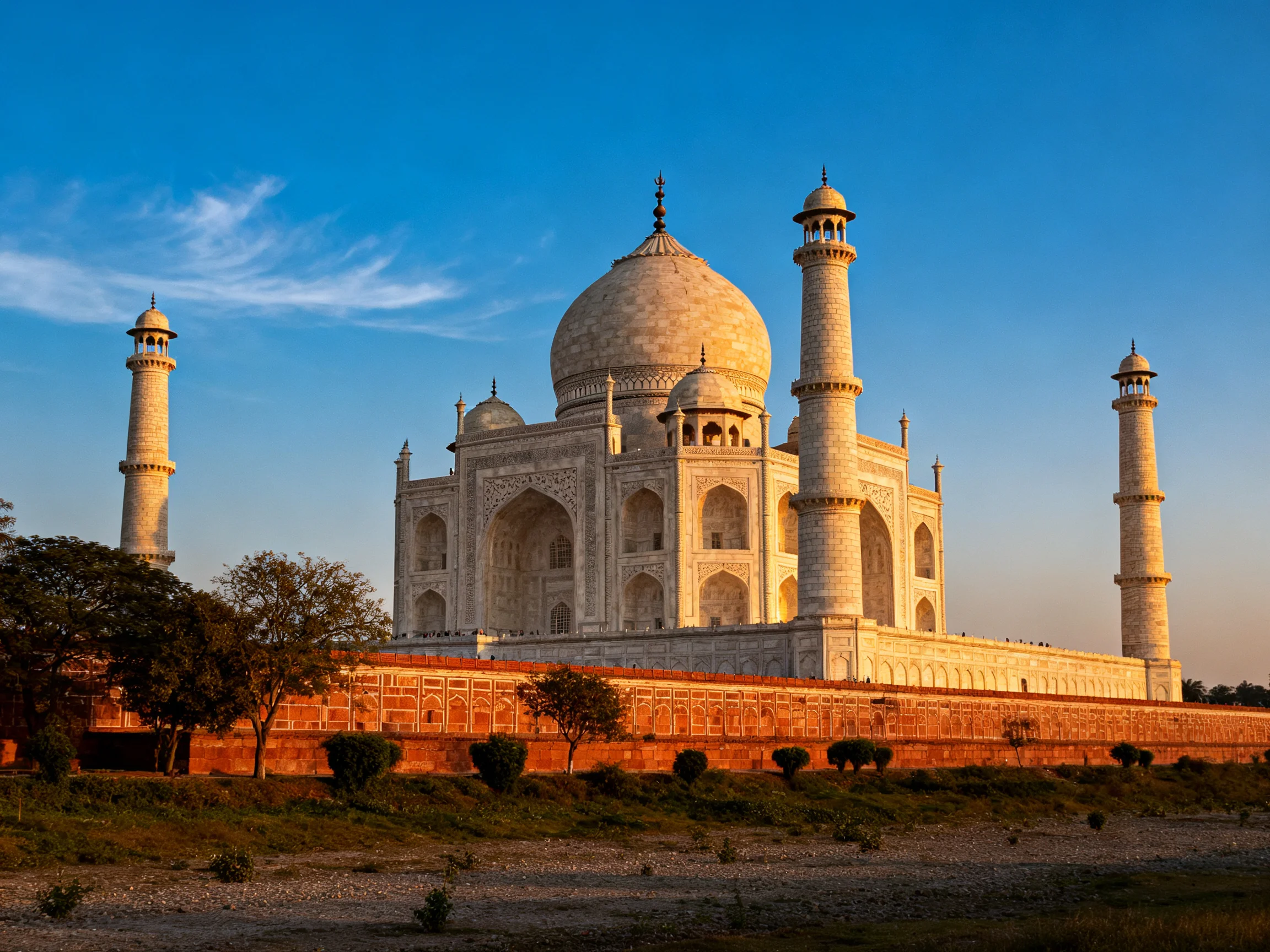 The Taj Mahals white marble glows in golden evening light